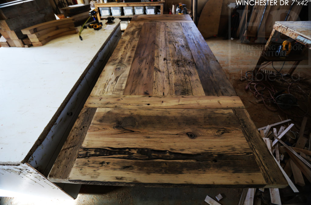 Details: 7' Reclaimed Wood Table for Waterloo Home - 42" wide - Trestle Base - Hemlock Threshing Floor Construction / Medium Sanding out of Original Patina - Original edges & distressing maintained - Premium epoxy + Satin Polyurethane Finish - 7' [Matching] Reclaimed Wood Bench - 5 Hudson Chairs / Wormy Maple / Black with Sandthroughs Frame / Seat Stained Dominant Tone of Table Top - www.hdthreshing.com