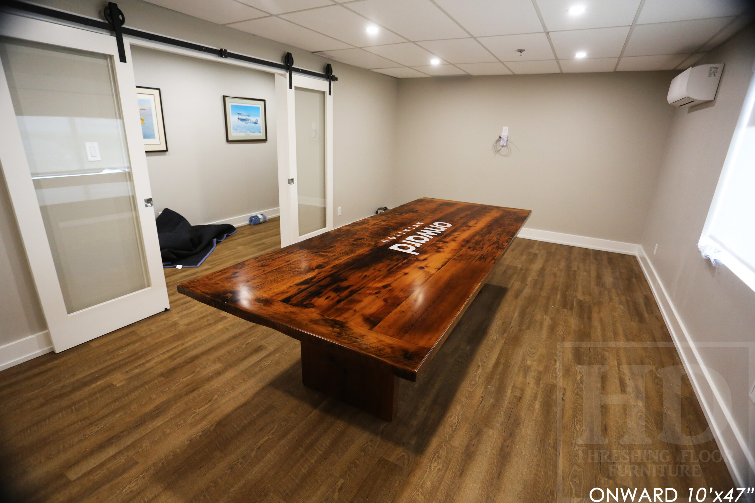 10 ft Reclaimed Wood Boardroom Table - 47" wide - Reclaimed Hemlock Threshing Floor Construction - Original edges & distressing maintained - Modern Plank style base - Custom metal logo routered into top - Premium epoxy + satin polyurethane finish / www.table.ca