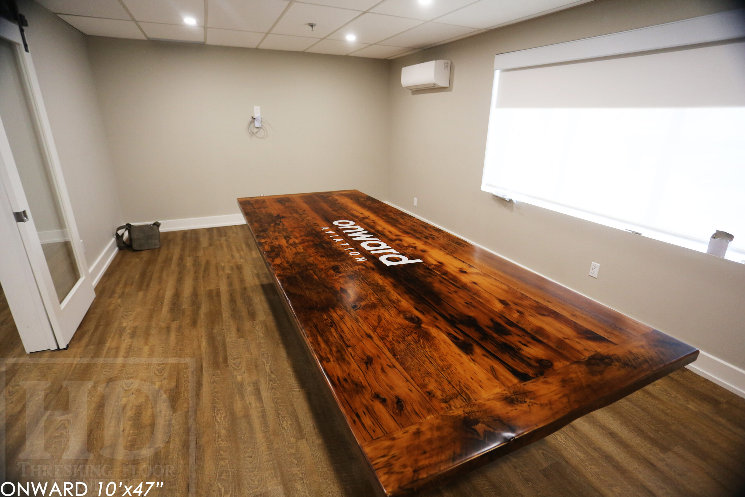 10 ft Reclaimed Wood Boardroom Table - 47" wide - Reclaimed Hemlock Threshing Floor Construction - Original edges & distressing maintained - Modern Plank style base - Custom metal logo routered into top - Premium epoxy + satin polyurethane finish / www.table.ca