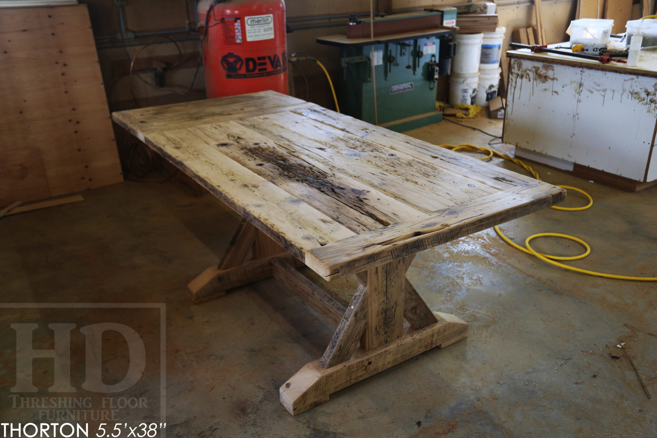 5.5' Reclaimed Wood Table we made for an Ontario home - 38" wide - Sawbuck Base / Painted Black - Old Growth Hemlock Threshing Floor Construction - Original edges & distressing maintained - Premium epoxy + satin polyurethane finish - 5' Trestle Bench - www.table.ca