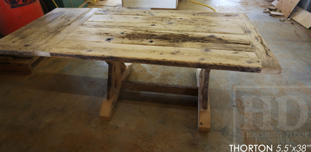 5.5' Reclaimed Wood Table we made for an Ontario home - 38" wide - Sawbuck Base / Painted Black - Old Growth Hemlock Threshing Floor Construction - Original edges & distressing maintained - Premium epoxy + satin polyurethane finish - 5' Trestle Bench - www.table.ca