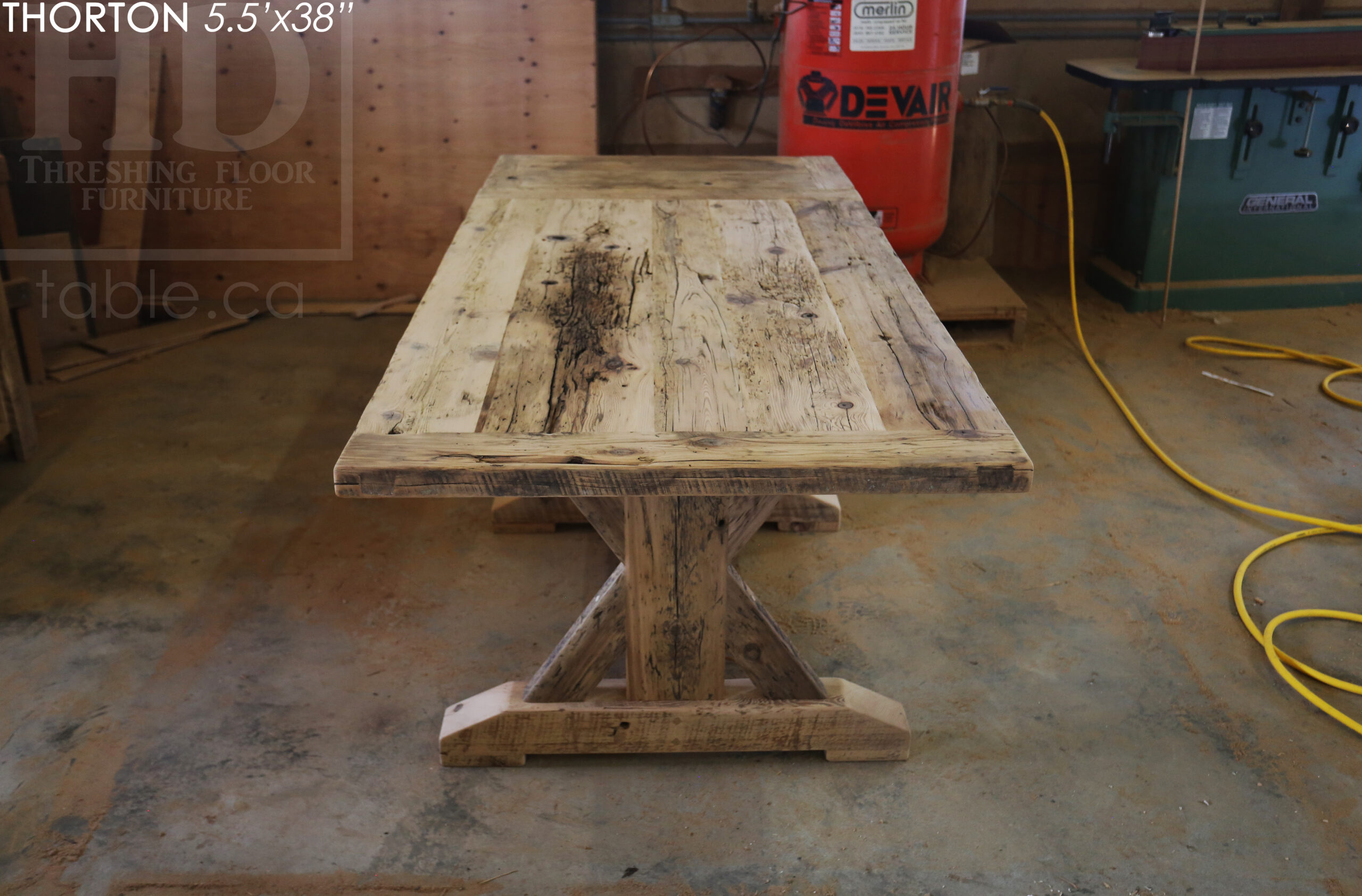 5.5' Reclaimed Wood Table we made for an Ontario home - 38" wide - Sawbuck Base / Painted Black - Old Growth Hemlock Threshing Floor Construction - Original edges & distressing maintained - Premium epoxy + satin polyurethane finish - 5' Trestle Bench - www.table.ca