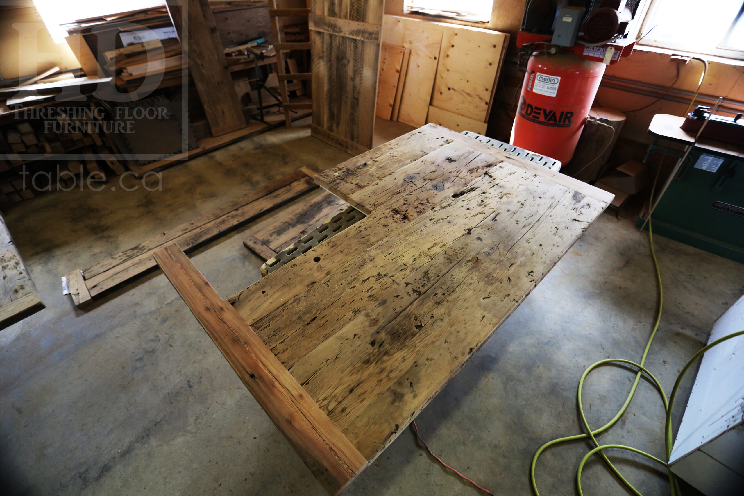 Custom Reclaimed Wood Island Top we made for a Wasaga Beach, Ontario Home - 2" Hemlock Threshing Floor Construction - Original Ontario barnwood edges & distressing maintained - Premium epoxy + satin polyurethane finish - www.table.ca