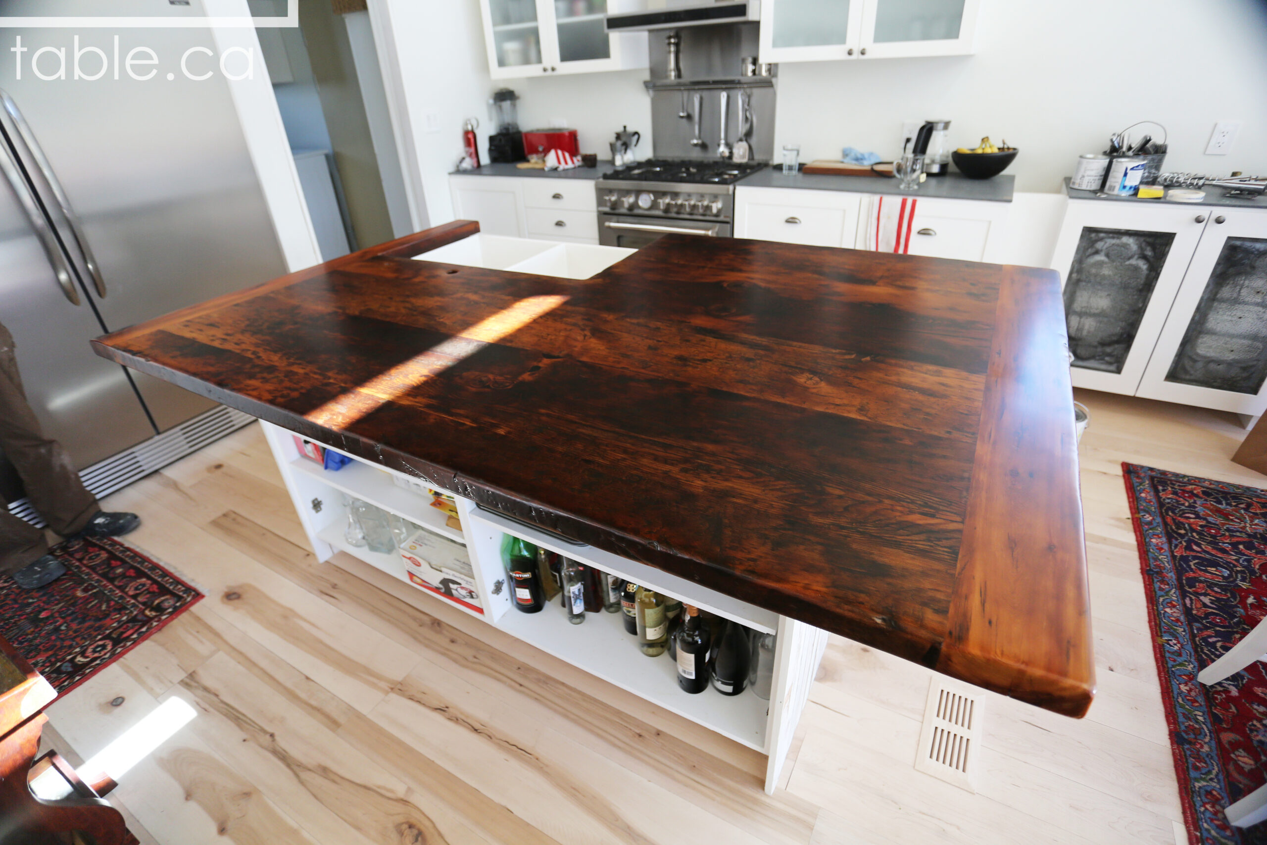 Custom Reclaimed Wood Island Top we made for a Wasaga Beach, Ontario Home - 2" Hemlock Threshing Floor Construction - Original Ontario barnwood edges & distressing maintained - Premium epoxy + satin polyurethane finish - www.table.ca