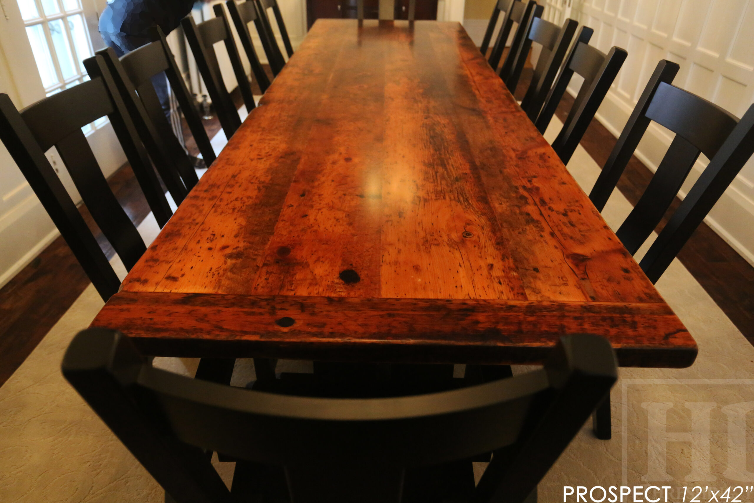 12' Reclaimed Wood Table for a Port Dover home - 42" wide - Trestle Base - 2" Old Growth Pine Threshing Floor Construction - Original edges & distressing maintained - Premium epoxy + satin polyurethane finish - Black Painted Base - 12 Plank Back Chairs / Wormy Maple - Painted Solid Black / Satin polyurethane clearcoat finish - www.table.ca