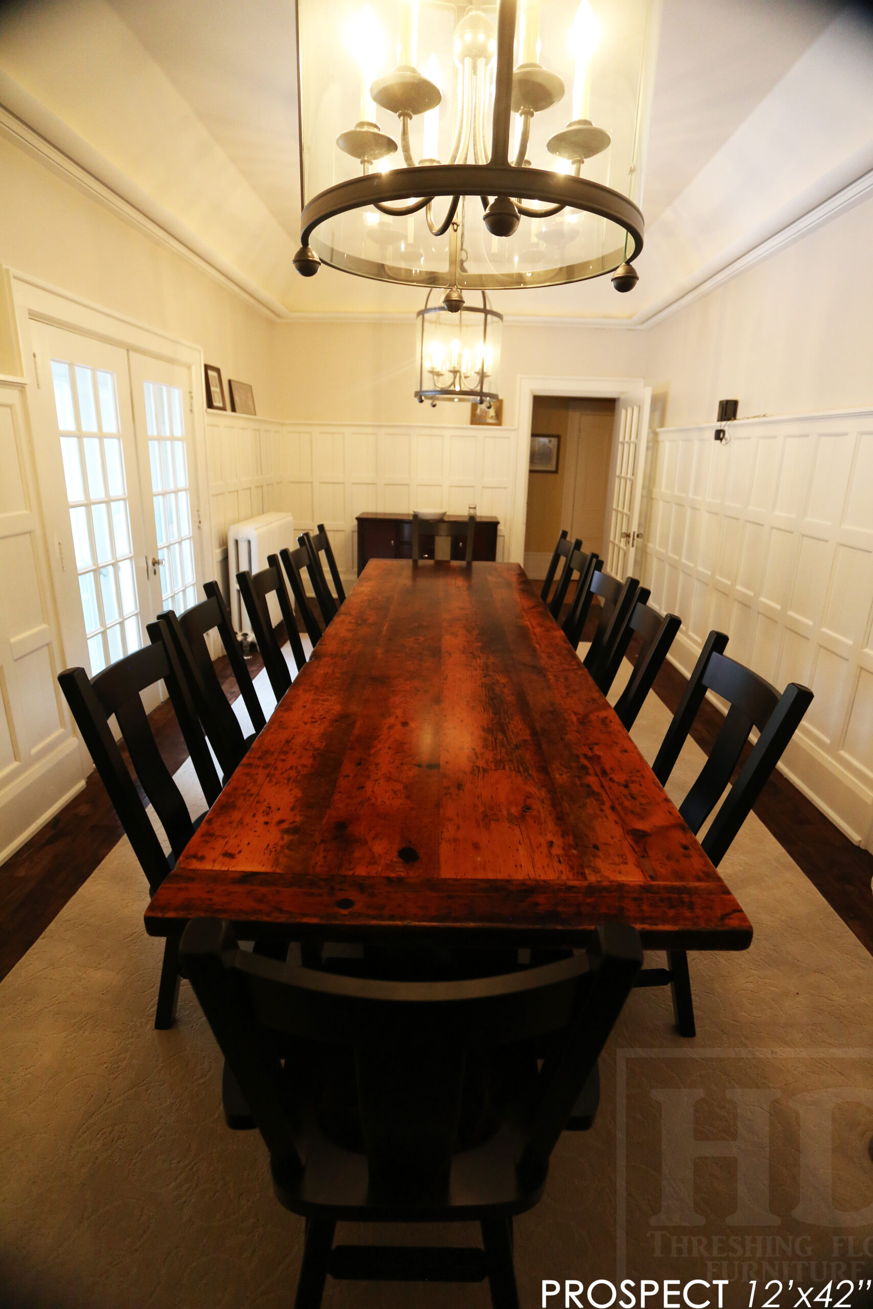 12' Reclaimed Wood Table for a Port Dover home - 42" wide - Trestle Base - 2" Old Growth Pine Threshing Floor Construction - Original edges & distressing maintained - Premium epoxy + satin polyurethane finish - Black Painted Base - 12 Plank Back Chairs / Wormy Maple - Painted Solid Black / Satin polyurethane clearcoat finish - www.table.ca