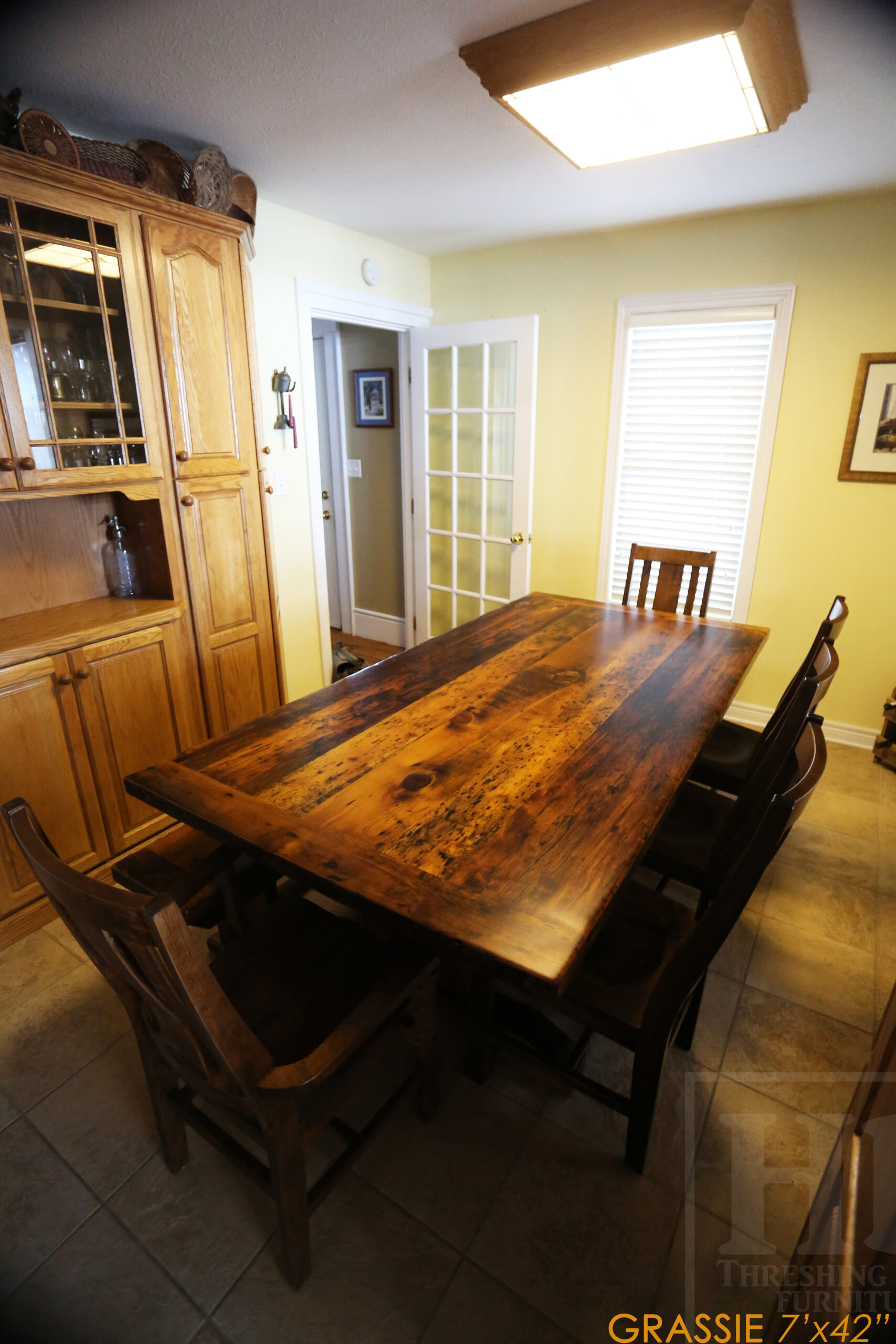 7' Ontario Barnwood Table for a Grassie, Ontario Home - 42" wide - Trestle Base - Reclaimed Old Growth Pine Threshing Floor Construction - Original Distressing & Character & Edges Maintained - Premium epoxy + satin polyurethane finish - One 18" Leaf Extension - 7' [matching] Trestle Bench - 5 Wormy Maple Chairs - Stained to match table - www.table.ca