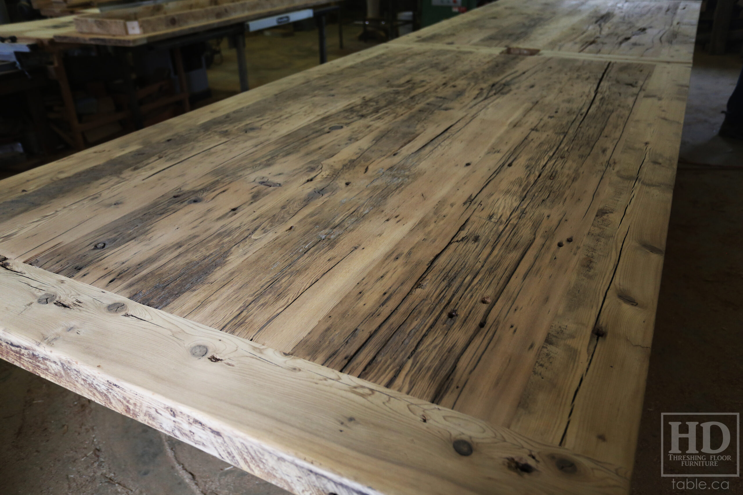 Project details: 17' Ontario Barnwood Boardroom Wood Table we made for a Beamsville, Ontario company - 60" wide – Steel U Shaped Base – Reclaimed Old Growth Hemlock Threshing Floor Construction – Black Stain Option – Centre on-site doweling - Original edges & distressing maintained – Premium epoxy + Satin polyurethane finish  – www.table.ca