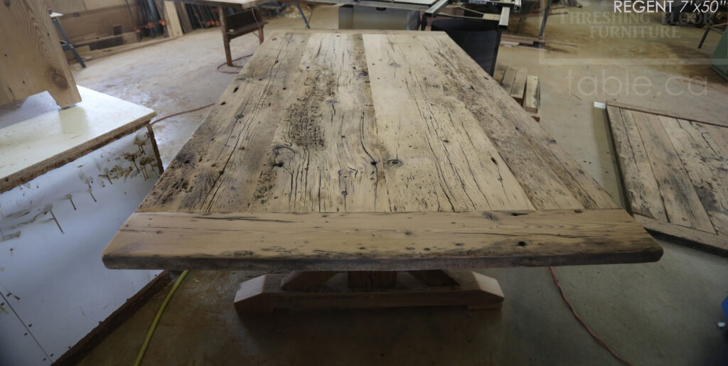 7 ft Reclaimed Ontario Barnwood Table we made for a Cambridge, Ontario home - 50â€ wide â€“ Sawbuck Base - Reclaimed Hemlock Threshing Floor Construction â€“ Original edges & distressing maintained â€“ Premium epoxy + High Gloss Option polyurethane finish â€“ Black painted with sandthroughs base - www.table.ca