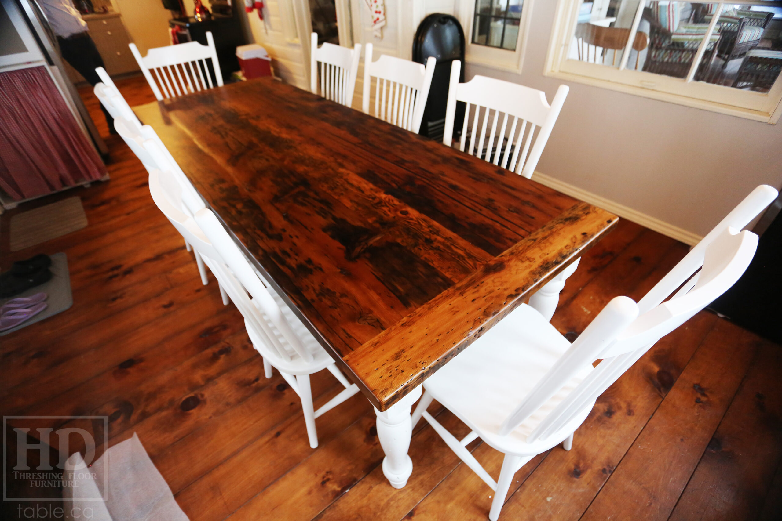 Project details: 8' Ontario Barnwood Table we made for a Kirkfield, Ontario cottage - 36" wide – Drawer Option at End Between Leaf Rails - Harvest Base / Turned Windbrace Beam Legs / White Painted Skirting & Legs – Reclaimed Old Growth Hemlock Threshing Floor Construction – Original edges & distressing maintained – Premium [light coating option] epoxy + matte polyurethane finish – Two 18” Leaf Extensions [making total length 11’ when extended] – 8 Buckhorn Chairs / Wormy Maple / Painted Solid White - www.table.ca