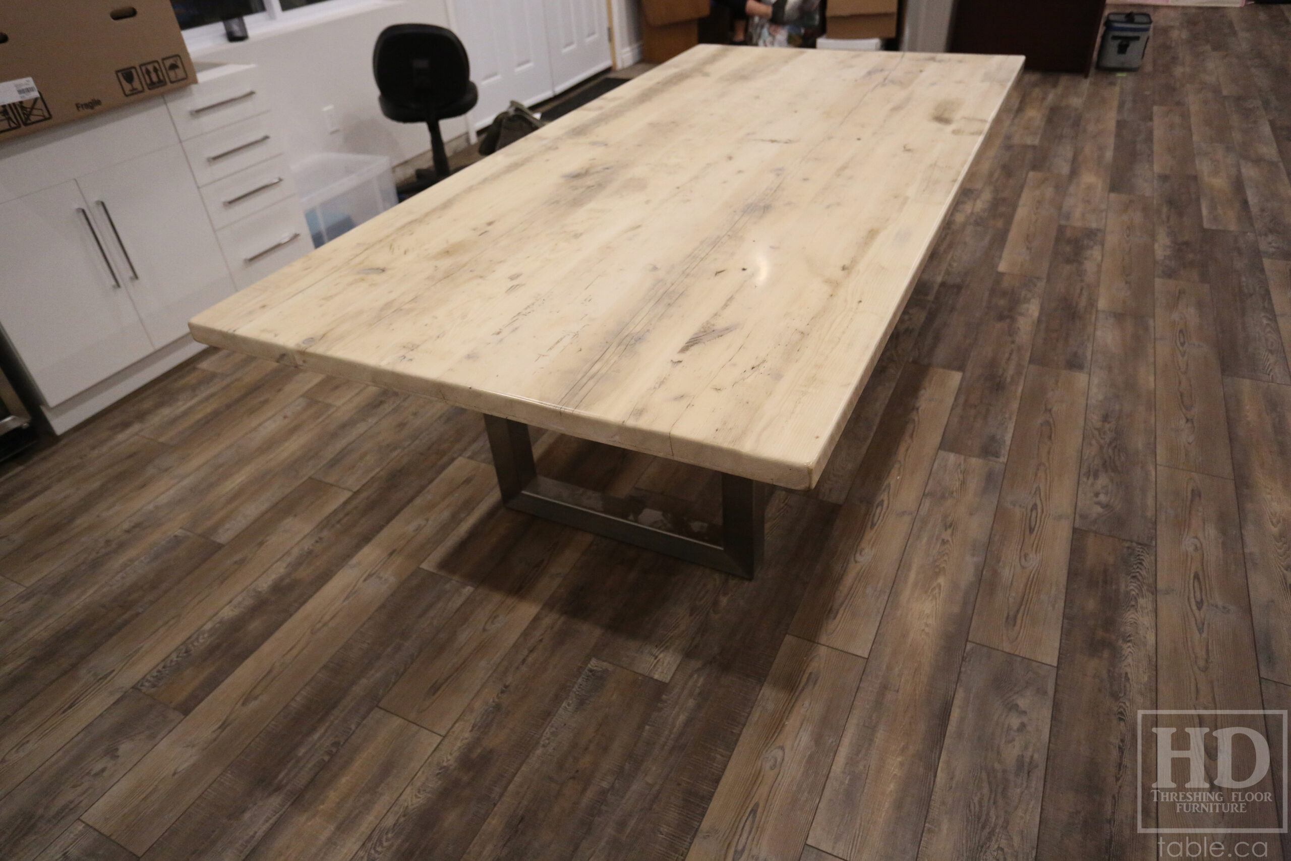 Project details: 8' Ontario Barnwood Boardroom Table - 48" wide â€“ Stainless Steel U Shaped Base â€“ Reclaimed Old Growth Hemlock Threshing Floor Construction â€“ No bread-edge boards - Original edges & distressing maintained â€“ Bleached Option - Premium epoxy + satin polyurethane finish - www.table.ca