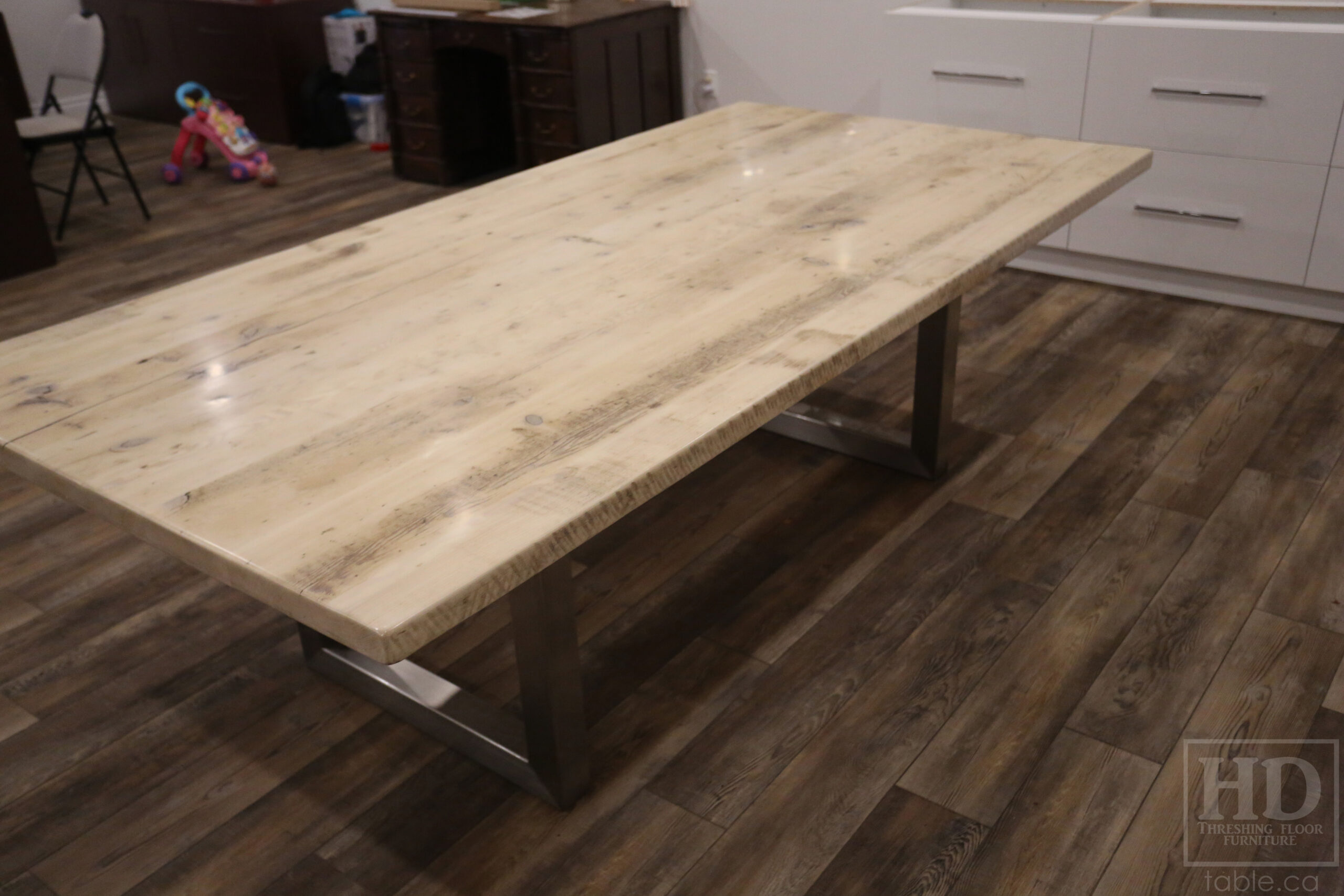 Project details: 8' Ontario Barnwood Boardroom Table - 48" wide â€“ Stainless Steel U Shaped Base â€“ Reclaimed Old Growth Hemlock Threshing Floor Construction â€“ No bread-edge boards - Original edges & distressing maintained â€“ Bleached Option - Premium epoxy + satin polyurethane finish - www.table.ca