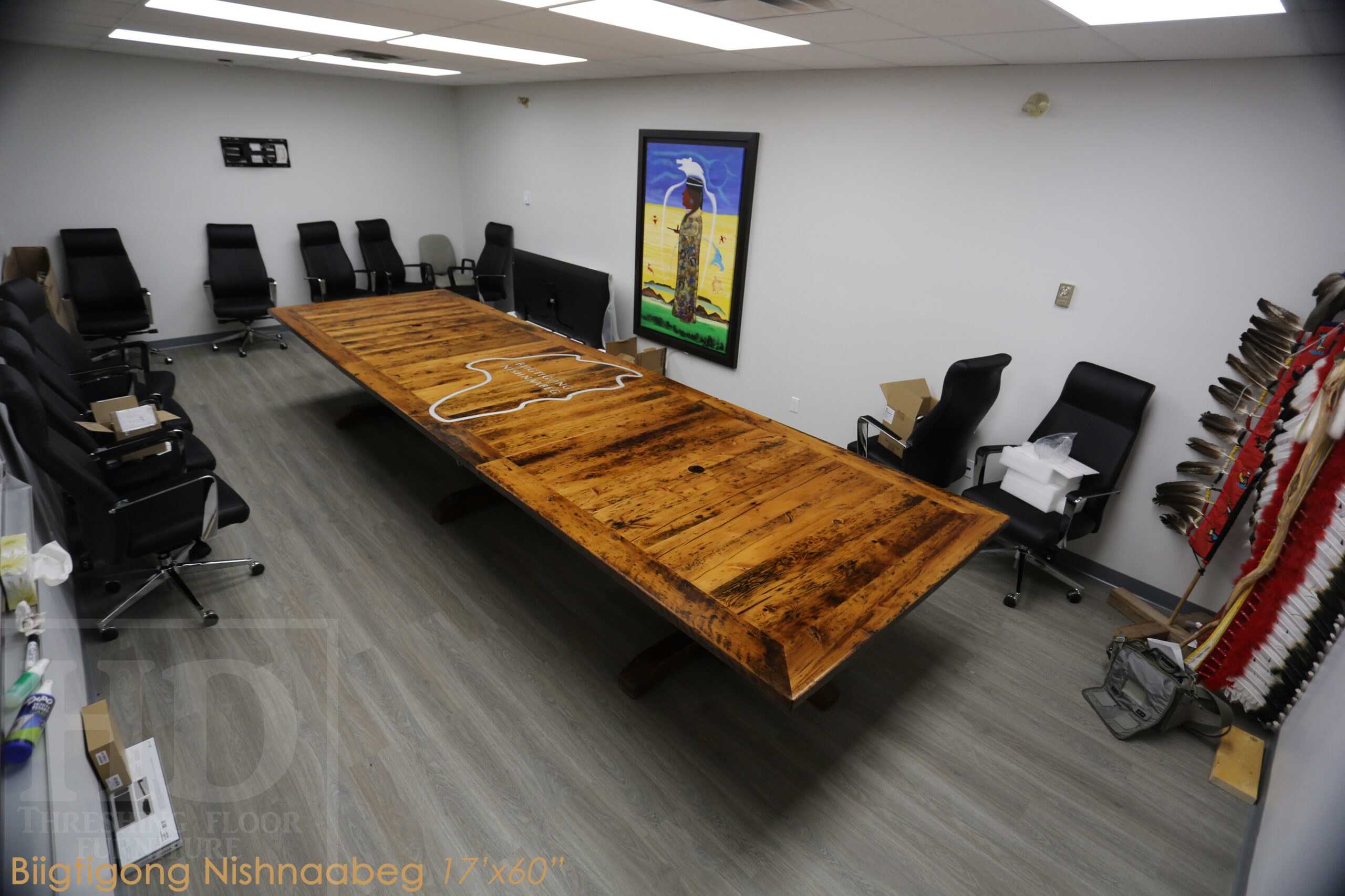 Project details: 17â€™ Reclaimed Ontario Barnwood Table we made for a Marathon, Ontario community centre â€“ Hand-Hewn Beam Pedestals Base - Old Growth Hemlock Threshing Floor Construction â€“ Original edges & distressing maintained â€“ Bread Edge Ends â€“ Custom Steel Graphic Embedded - Premium epoxy + satin polyurethane finish â€“ Top Built in 3 parts / Onsite Final Assembly - www.table.ca