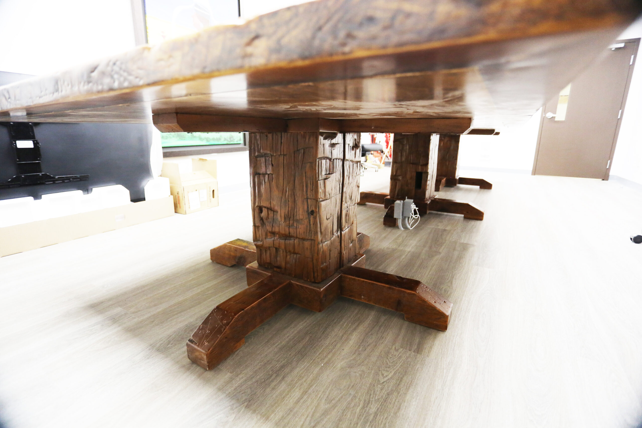 Project details: 17’ Reclaimed Ontario Barnwood Table we made for a Marathon, Ontario community centre – Hand-Hewn Beam Pedestals Base - Old Growth Hemlock Threshing Floor Construction – Original edges & distressing maintained – Bread Edge Ends – Custom Steel Graphic Embedded - Premium epoxy + satin polyurethane finish – Top Built in 3 parts / Onsite Final Assembly - www.table.ca