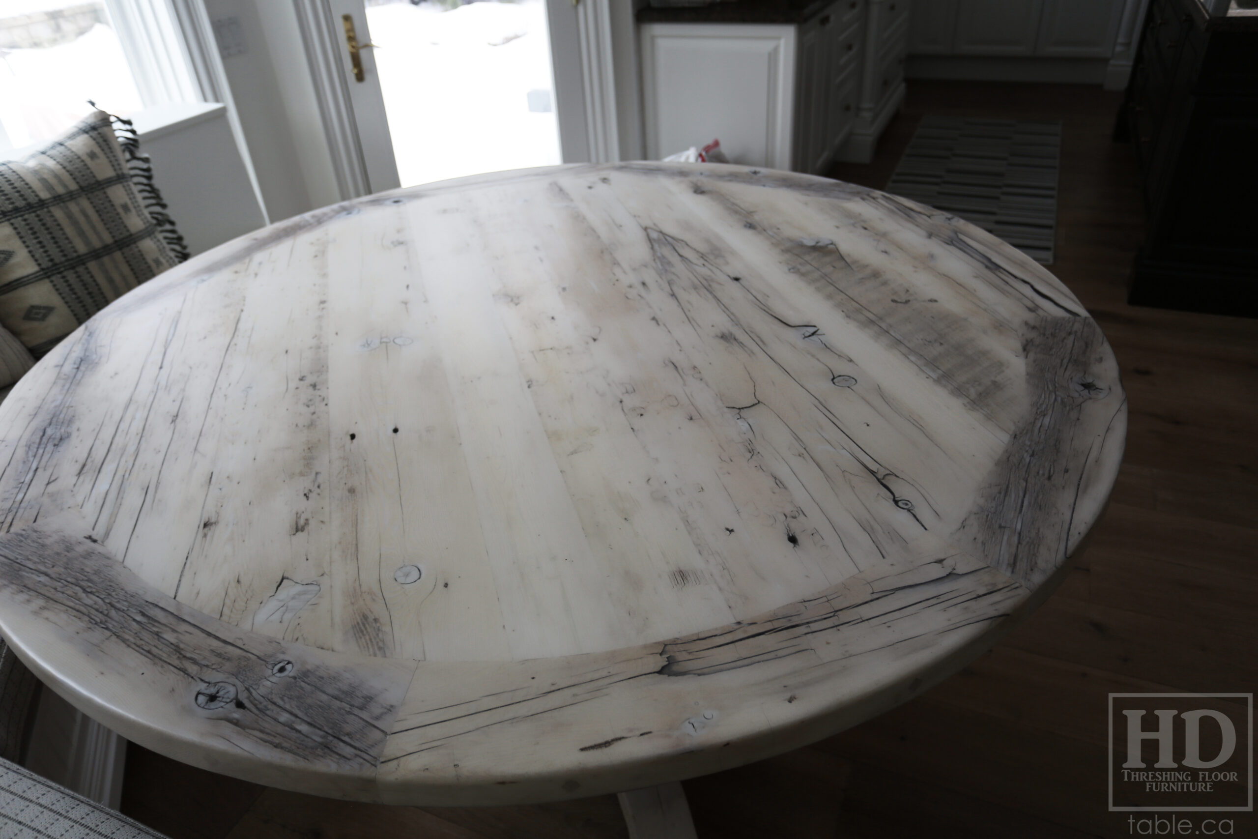 Project summary: 68” Round Reclaimed Ontario Barnwood Table we made for a Toronto, Ontario home – Hand-Hewn Beam Pedestal Base - Old Growth Hemlock Threshing Floor Construction – Original edges & distressing maintained – Circular Bread Edges – Bleached Option - Premium epoxy + super matte polyurethane finish – www.table.ca