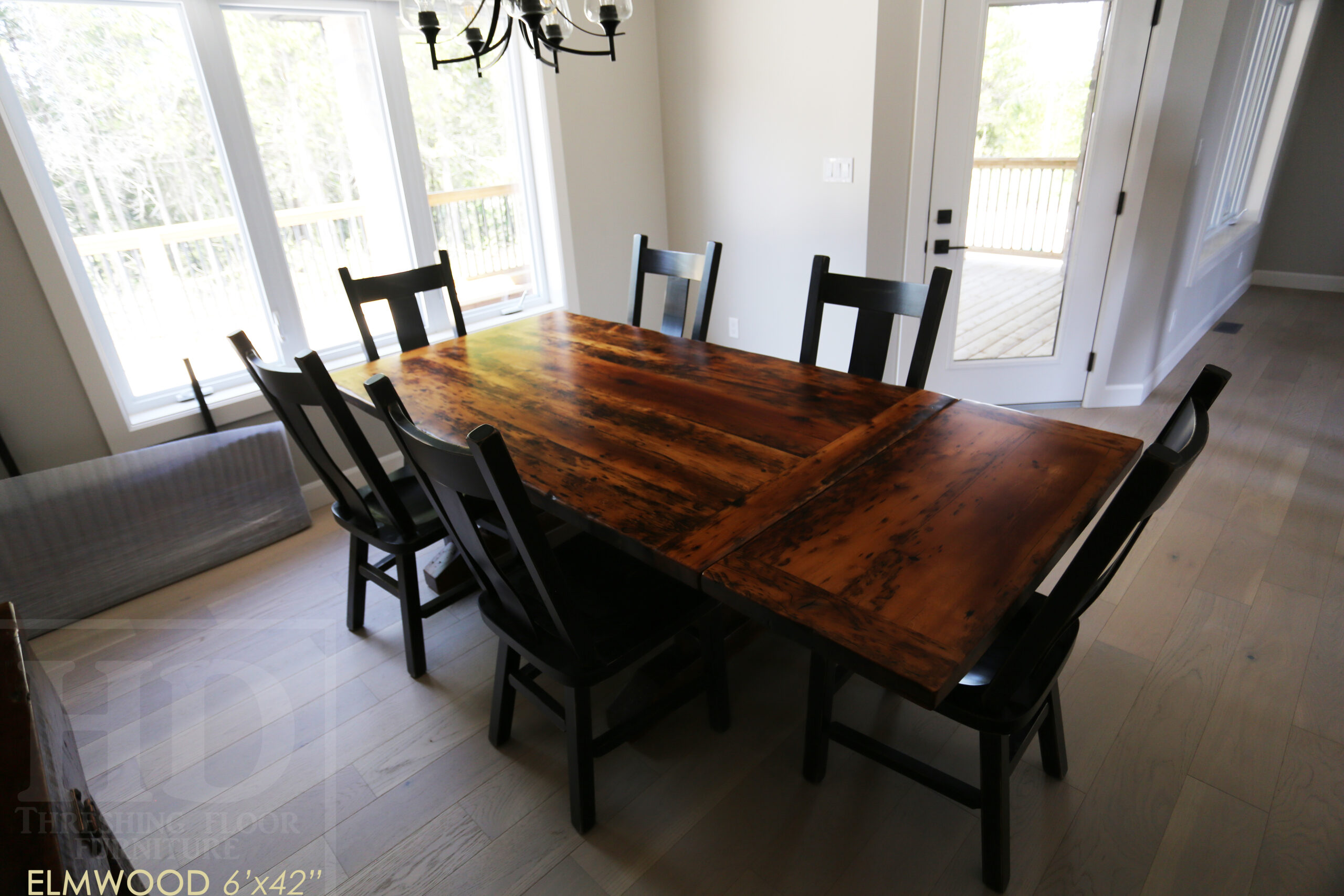 6’ Reclaimed Ontario Barnwood Table we made for an Elmwood, Ontario home – 42” wide – Trestle Base - Old Growth Hemlock Threshing Floor Construction - Original edges & distressing maintained – Bread Edge Board Ends – Premium epoxy + satin polyurethane finish – Two 18” Leaf Extensions – 6 Plank Back Chairs / Wormy Maple / Black with Sandthroughs / Polyurethane Clearcoat Finish - www.table.ca
