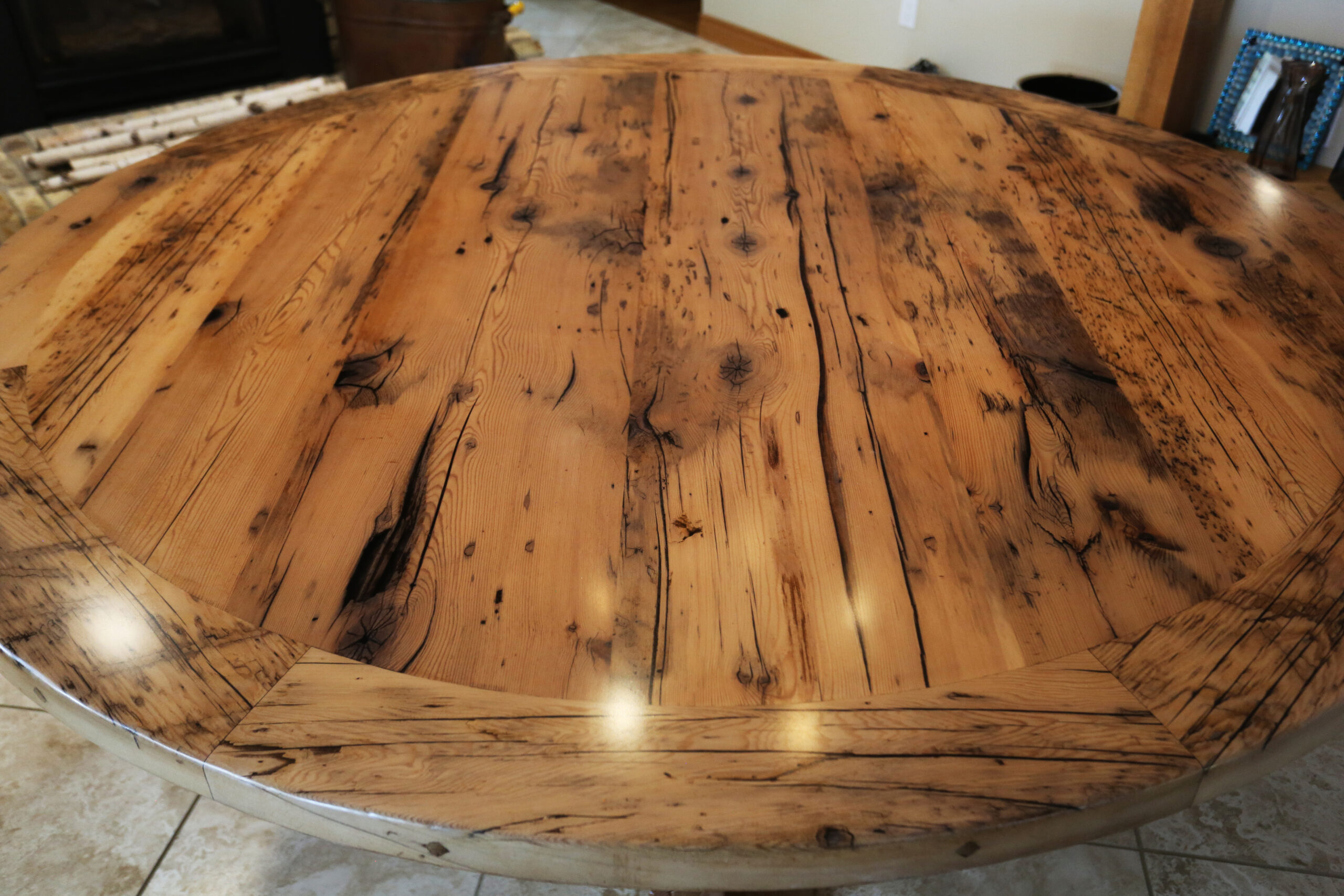 72” Reclaimed Ontario Barnwood Round Table we made for a Lakeside, Ontario home – Hand-Hewn Beam Post Base - Old Growth Hemlock Threshing Floor Construction - Original edges & distressing maintained – Bread Edge Boards –Premium epoxy + satin polyurethane finish – Greytone Option - www.table.ca