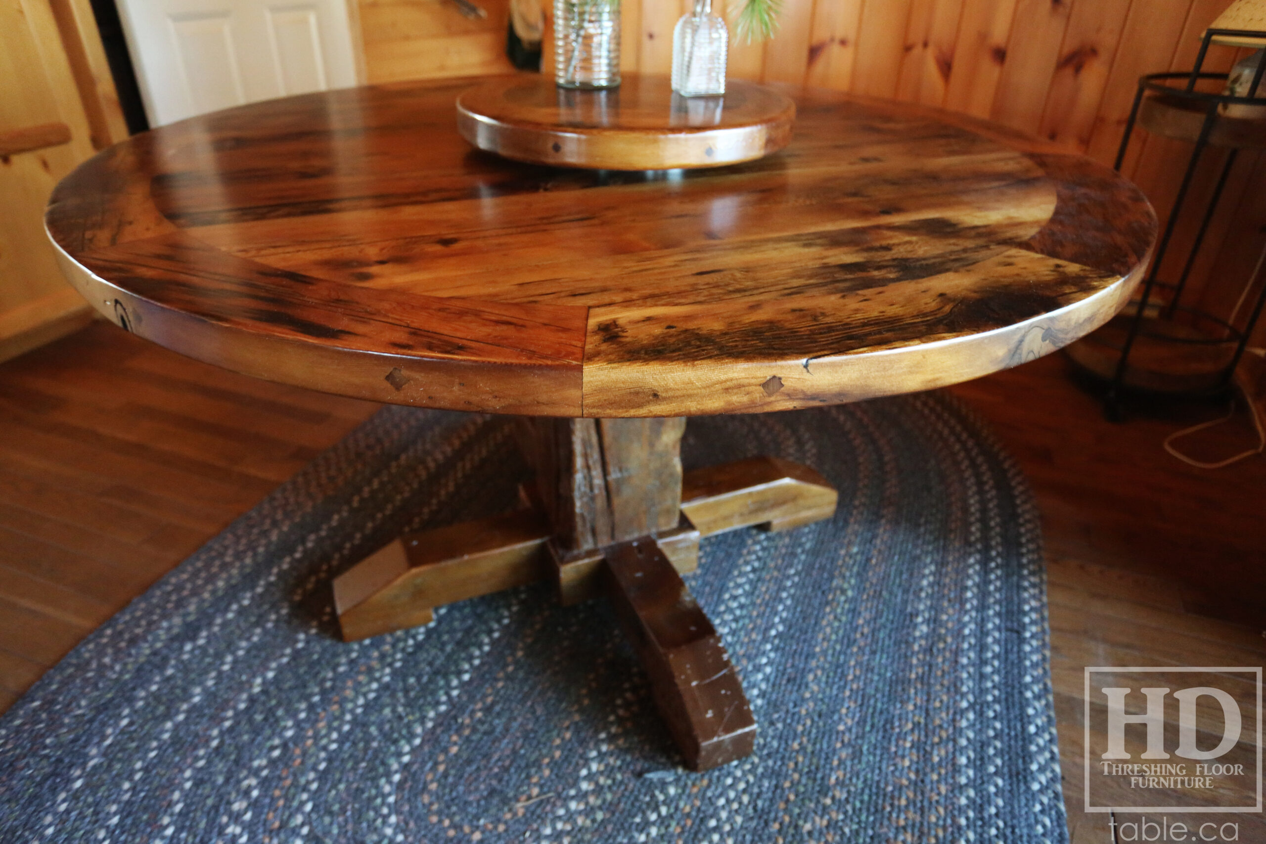 54” Reclaimed Ontario Barnwood Round Table we made for a Stoney Lake, Ontario cottage - Old Growth Hemlock Threshing Floor Construction – Hand-Hewn Beam Pedestal Base - Original edges & distressing maintained – Circular Bread Edge Boards – Premium epoxy + satin polyurethane finish – 18” Round Lazy Susan - www.table.ca
