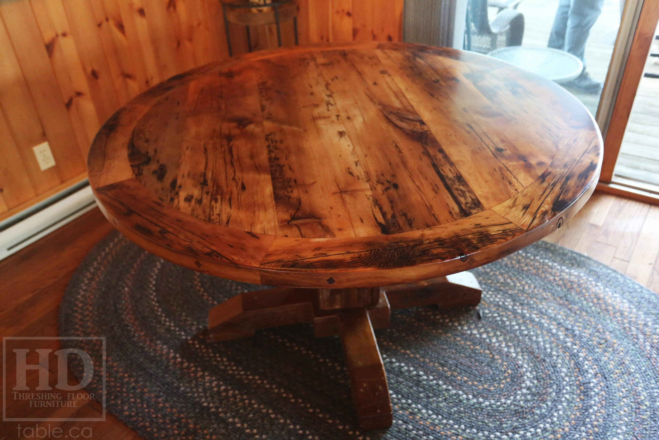 54” Reclaimed Ontario Barnwood Round Table we made for a Stoney Lake, Ontario cottage - Old Growth Hemlock Threshing Floor Construction – Hand-Hewn Beam Pedestal Base - Original edges & distressing maintained – Circular Bread Edge Boards – Premium epoxy + satin polyurethane finish – 18” Round Lazy Susan - www.table.ca