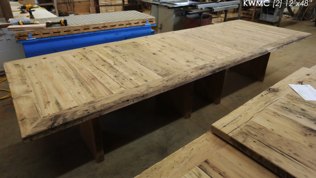 Project Summary: [TWO] 12’ Reclaimed Barnwood Tables we made for a Kitchener, Ontario organization – 48” wide – Plank 3” Joist Material Bases – 2 Underside rails to hide electronics - Old Growth Hemlock Threshing Floor  Construction - Original edges & distressing maintained – Bread Edge Boards – Premium epoxy + satin polyurethane finish – Grommet holes cut -  www.table.ca