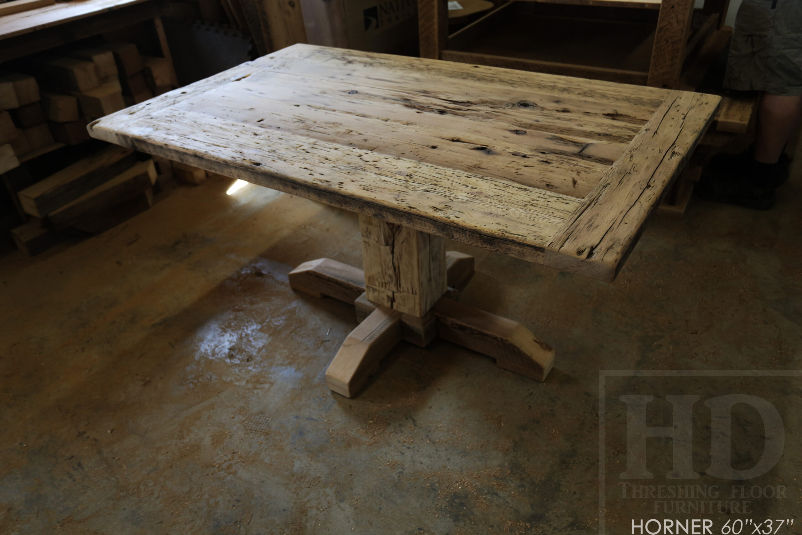 Project Summary: 60â€ Reclaimed Ontario Barnwood Coffee Table â€“ 37â€ wide â€“ 30â€ height â€“ Hand-Hewn Beam Pedestal Base -  Old Growth Hemlock Threshing Floor Construction - Original edges & distressing maintained â€“ Bread Edge Boards â€“ Greytone Option - Premium epoxy + satin polyurethane finish - www.table.ca