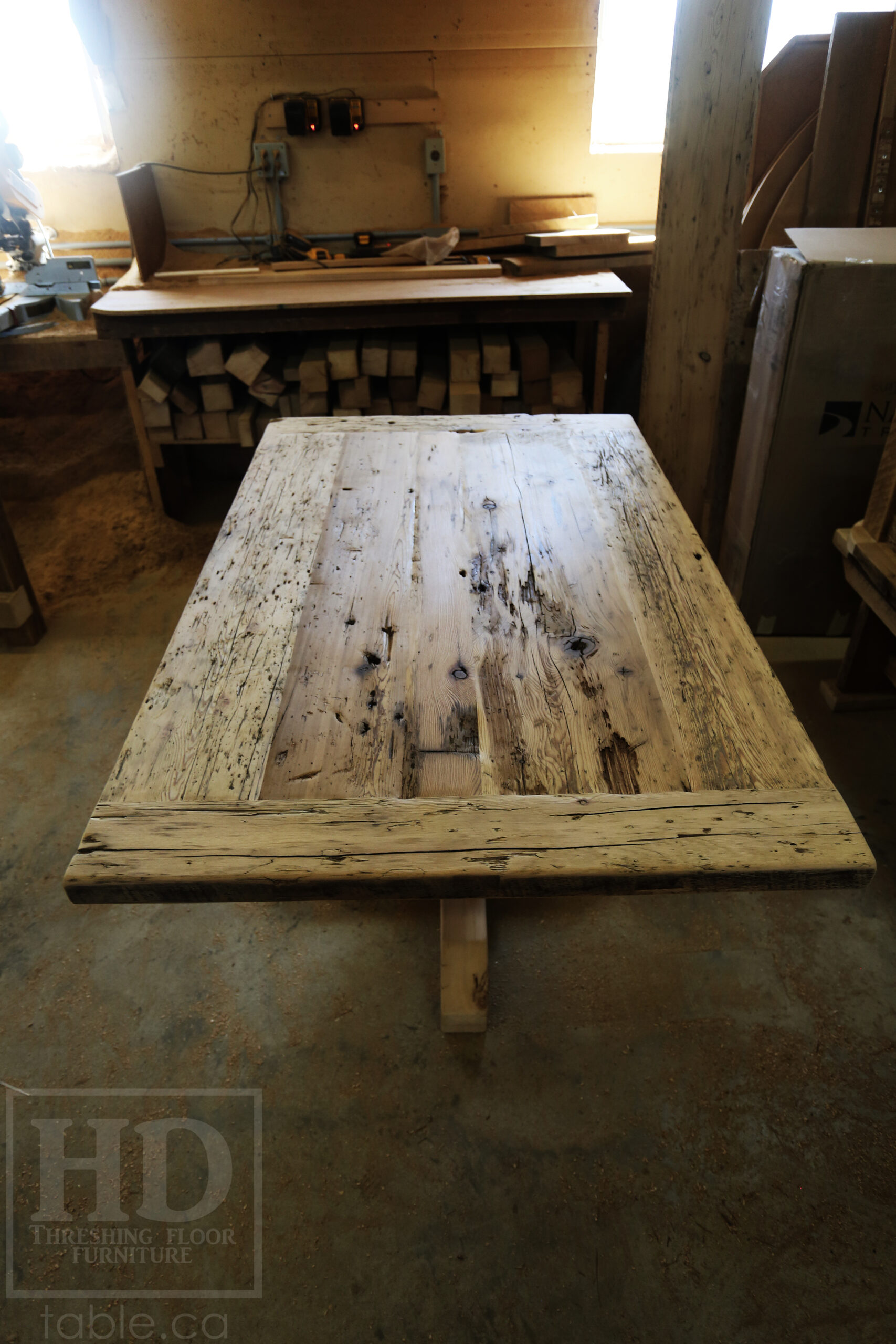 Project Summary: 60â€ Reclaimed Ontario Barnwood Coffee Table â€“ 37â€ wide â€“ 30â€ height â€“ Hand-Hewn Beam Pedestal Base -  Old Growth Hemlock Threshing Floor Construction - Original edges & distressing maintained â€“ Bread Edge Boards â€“ Greytone Option - Premium epoxy + satin polyurethane finish - www.table.ca