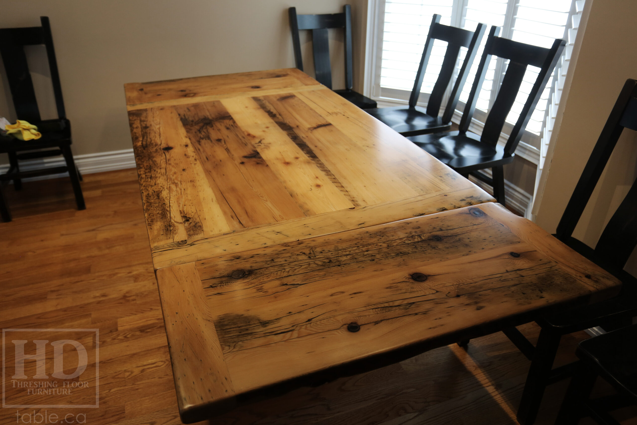 Project Summary: 5’ Reclaimed Barnwood Table we made for a Caledonia, Ontario home – 42” wide - Sawbuck Base [Painted Black] - Old Growth Hemlock Threshing Floor 2” Construction - Original edges & distressing maintained – Bread Edge Boards – Greytone Option - Premium epoxy + satin polyurethane finish – Two 12” Leaves – Wormy Maple Plank Back Chairs / Painted Black with Sandthroughs - www.table.ca