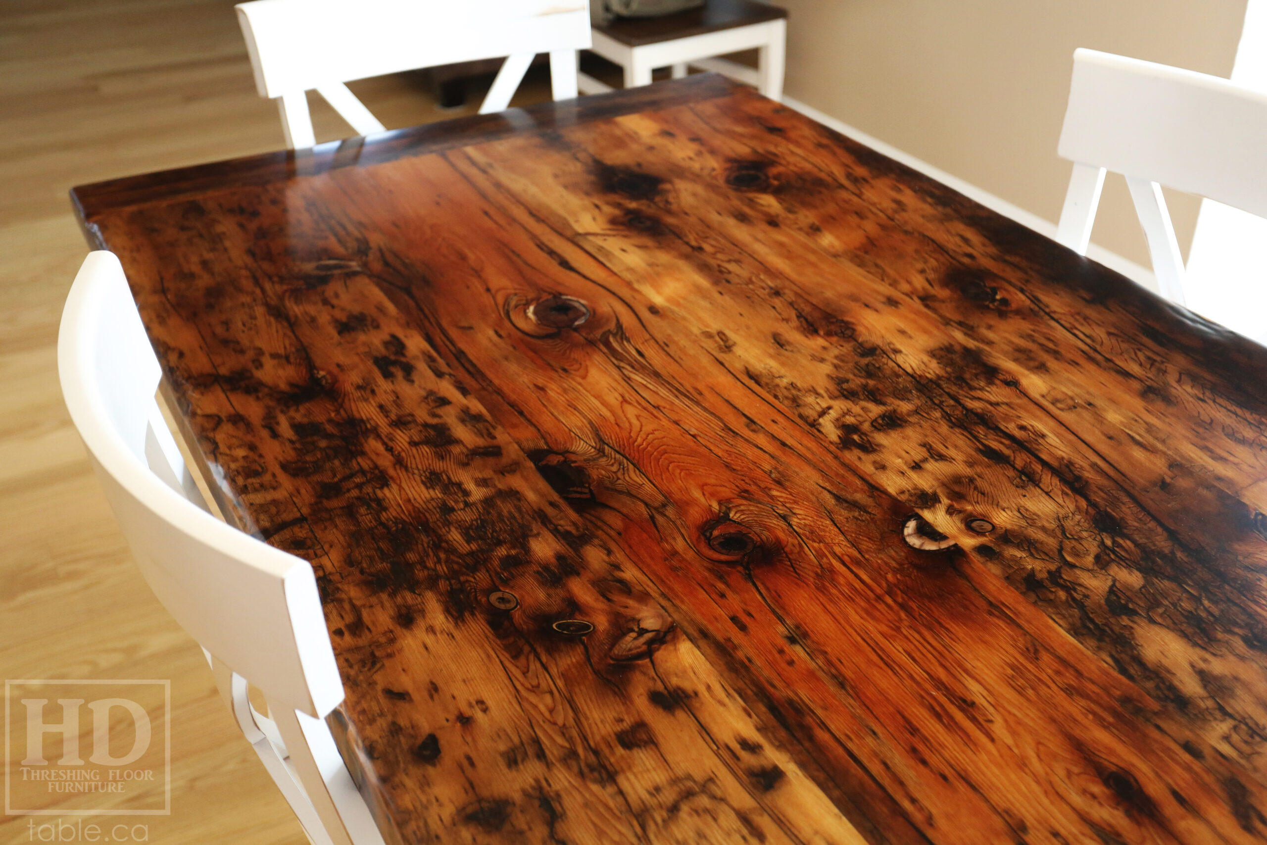 Project Summary: 6’ Reclaimed Ontario Barnwood Table we made for a Schomberg, Ontario home – 38” wide – Harvest Base: Turned Windbrace Beam Legs [18” inset from ends] / White with Sandthroughs Skirting & Legs - Old Growth Hemlock Threshing Floor Construction - Original edges & distressing maintained – Bread Edge Boards – Premium epoxy + satin polyurethane finish – One 18” Leaf Extension – [6] X Back Chairs / Wormy Maple / White with Sandthroughs Frame + Seat Stained Colour of Table Top – Polyurethane clearcoat finish - www.table.ca
