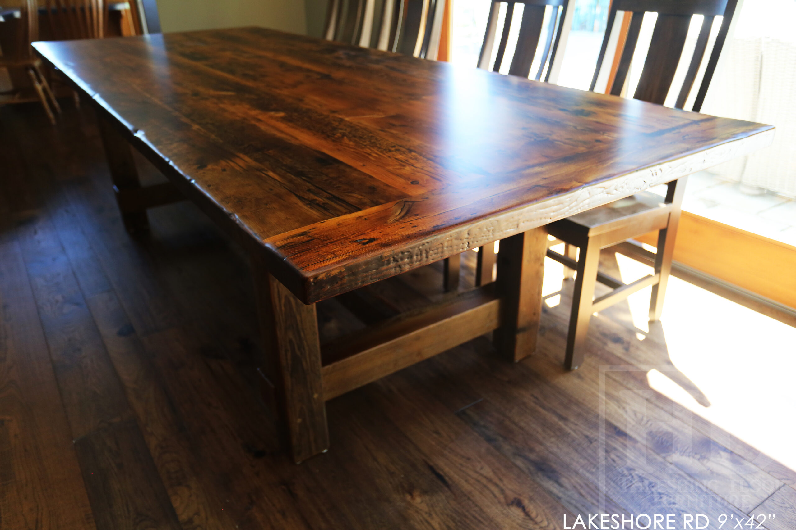 Project Summary: 9’ Reclaimed Ontario Barnwood Frame Table we made for a St. Catherines, Ontario Home – 42” wide - Old Growth Hemlock Threshing Floor Construction - Original edges & distressing maintained – Bread Edge Boards - Premium epoxy + matte polyurethane finish – 10 Sorority Chairs / Wormy Maple / Stained Dominant Tone of Table / Polyurethane Clearcoat Finish - www.table.ca