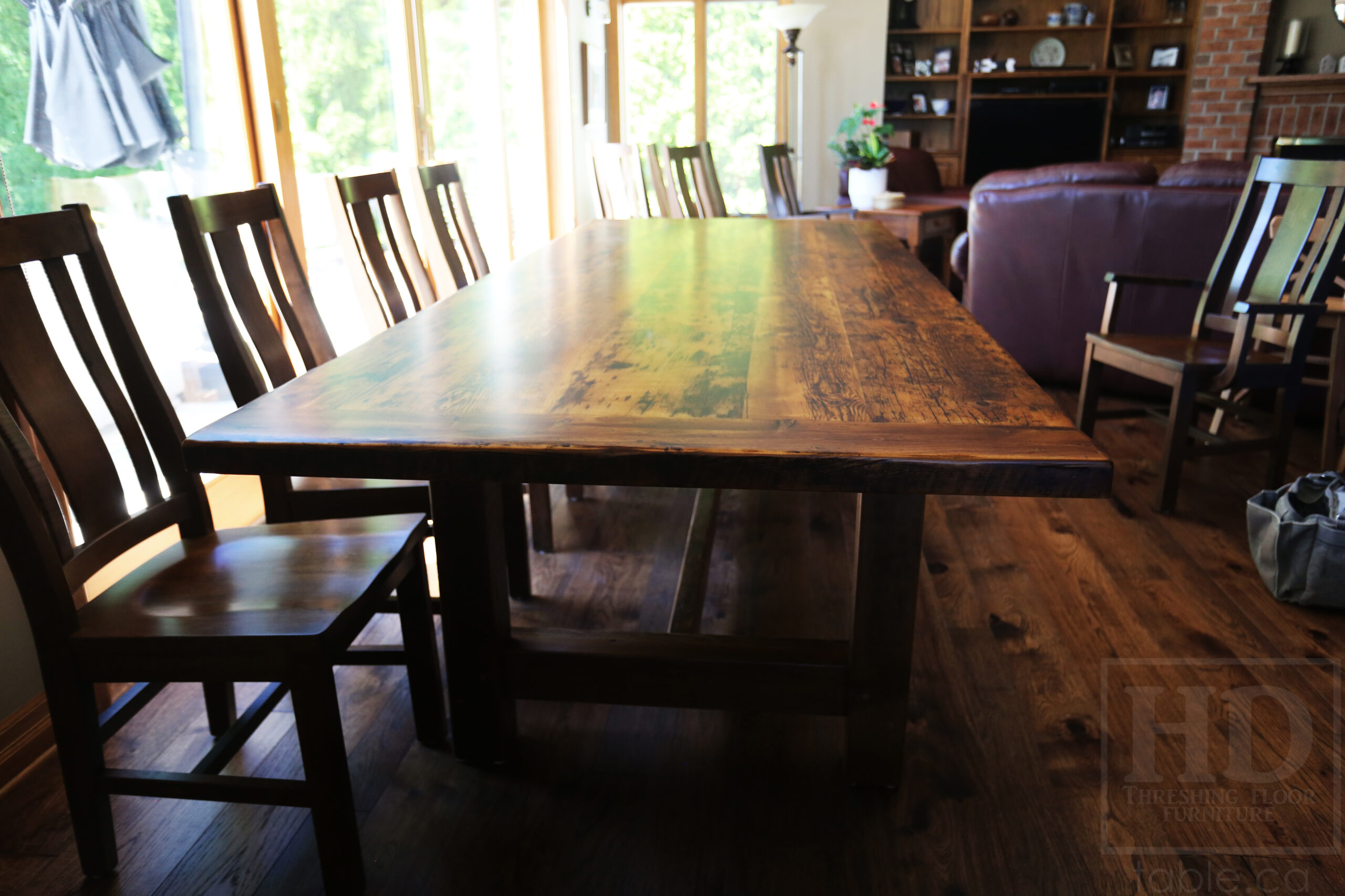 Project Summary: 9â€™ Reclaimed Ontario Barnwood Frame Table we made for a St. Catherines, Ontario Home â€“ 42â€ wide - Old Growth Hemlock Threshing Floor Construction - Original edges & distressing maintained â€“ Bread Edge Boards - Premium epoxy + matte polyurethane finish â€“ 10 Sorority Chairs / Wormy Maple / Stained Dominant Tone of Table / Polyurethane Clearcoat Finish - www.table.ca