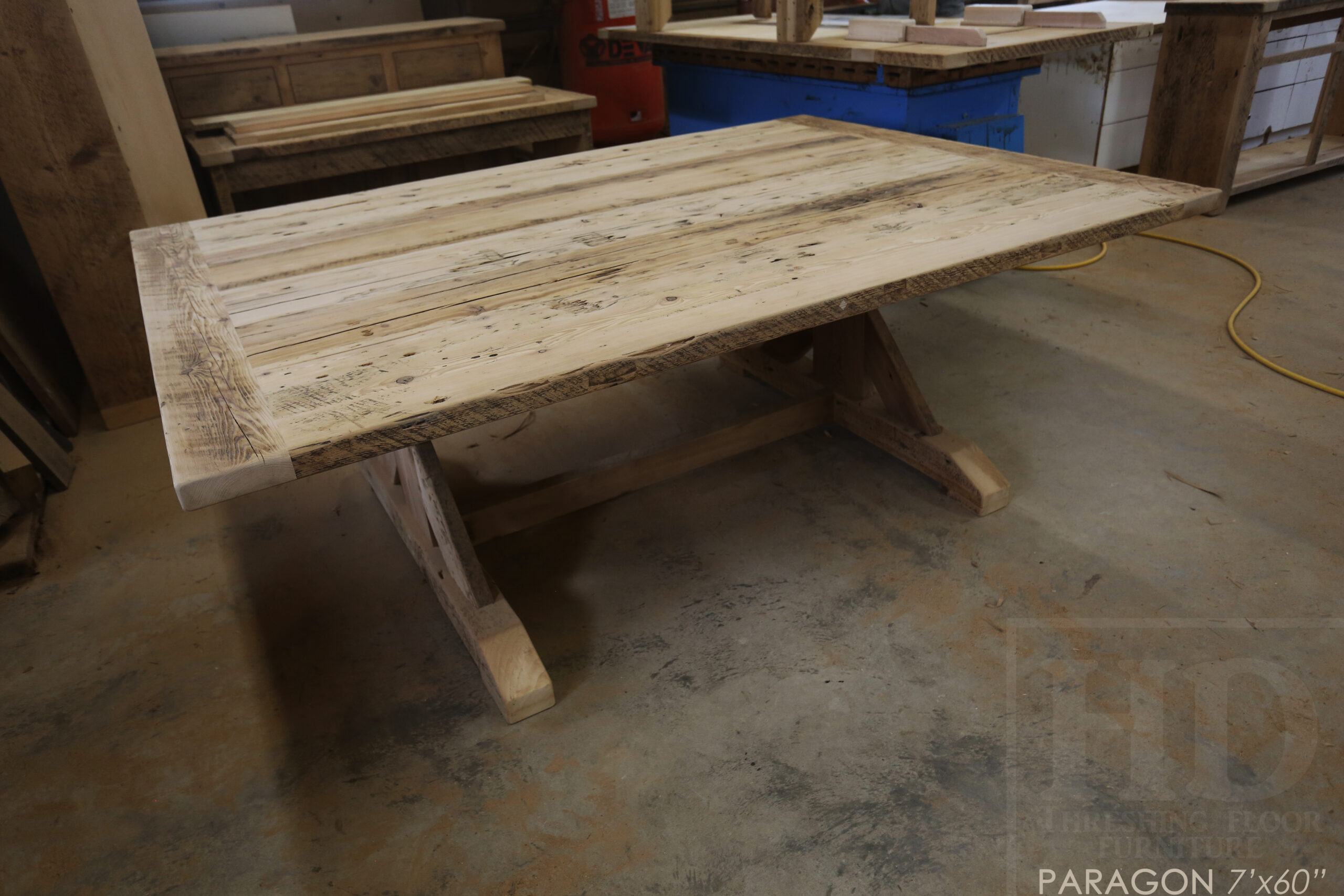 Project Summary: 7’ Reclaimed Barnwood Table we made for a Toronto, Ontario home – 60” wide – Sawbuck Base - Old Growth Ontario Hemlock Threshing Floor Construction - Original edges & distressing maintained – Bread Edge Boards – Premium epoxy + satin polyurethane finish -  www.table.ca