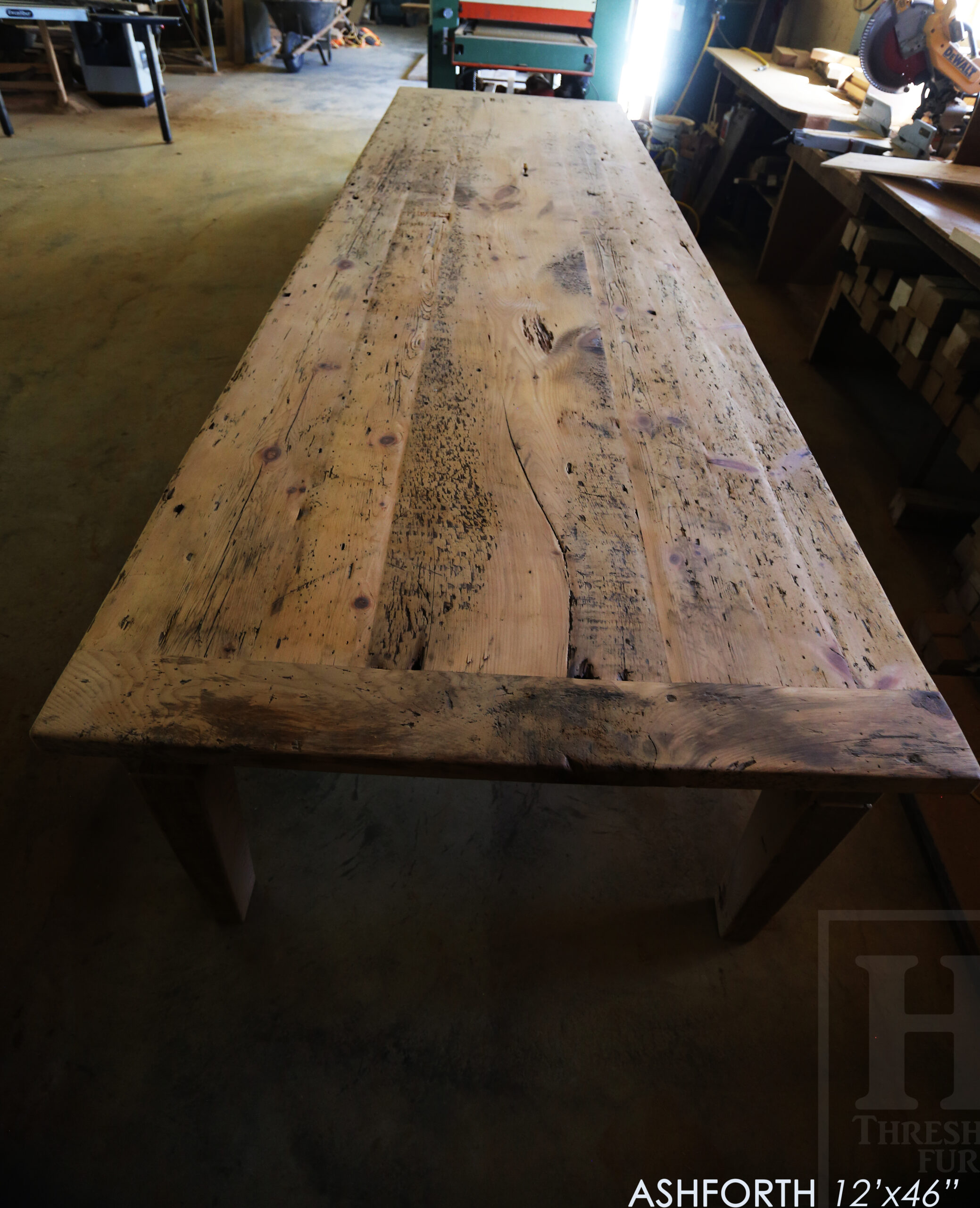 Project Summary: 12â€™ Reclaimed Ontario Barnwood Harvest Table â€“ Tapered with a Notch Windbrace Beam Legs - Old Growth Hemlock Threshing Floor 2â€ Construction - Original edges & distressing maintained â€“ Bread Edge Boards â€“- Premium epoxy + satin polyurethane finish - www.table.ca