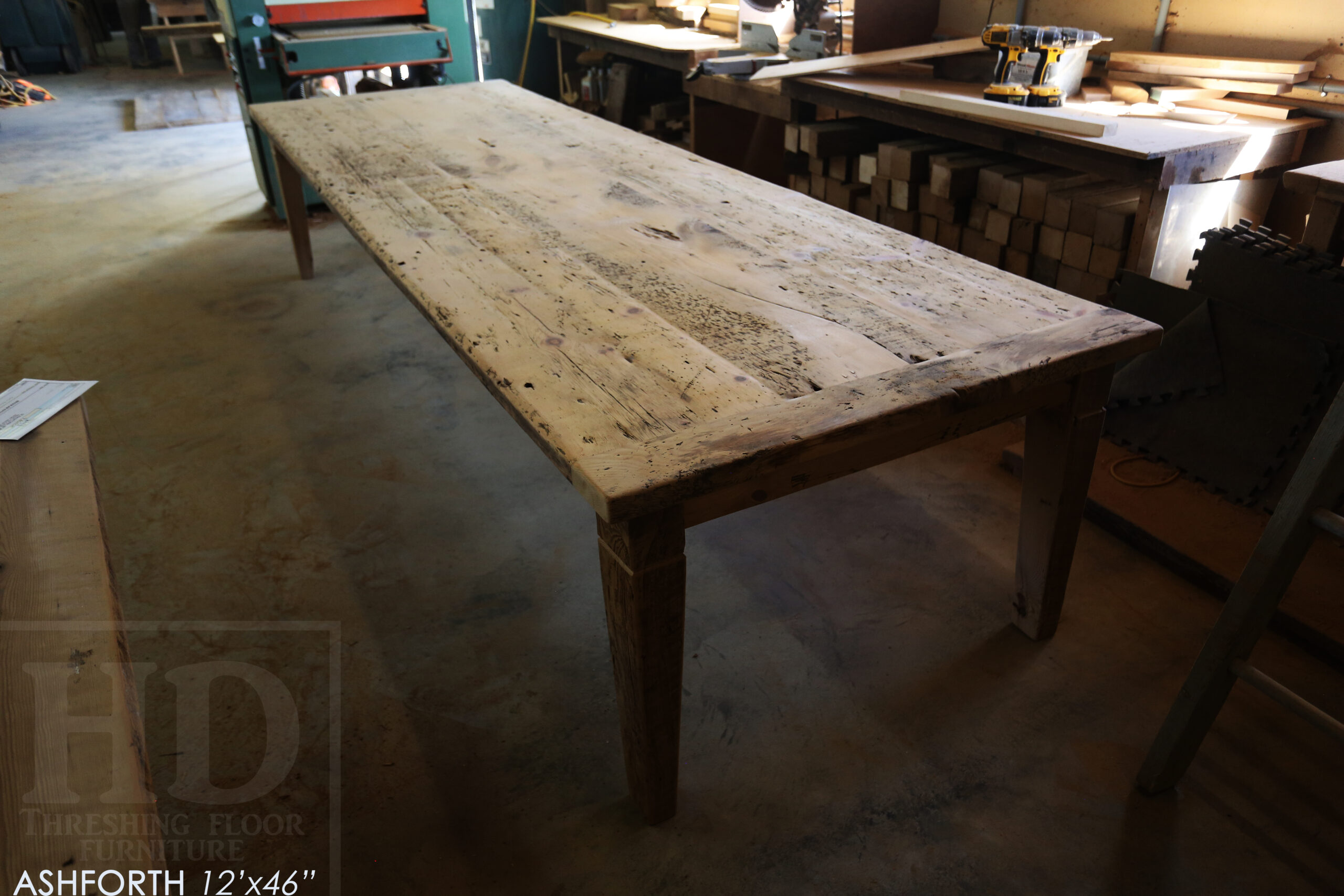 Project Summary: 12â€™ Reclaimed Ontario Barnwood Harvest Table â€“ Tapered with a Notch Windbrace Beam Legs - Old Growth Hemlock Threshing Floor 2â€ Construction - Original edges & distressing maintained â€“ Bread Edge Boards â€“- Premium epoxy + satin polyurethane finish - www.table.ca