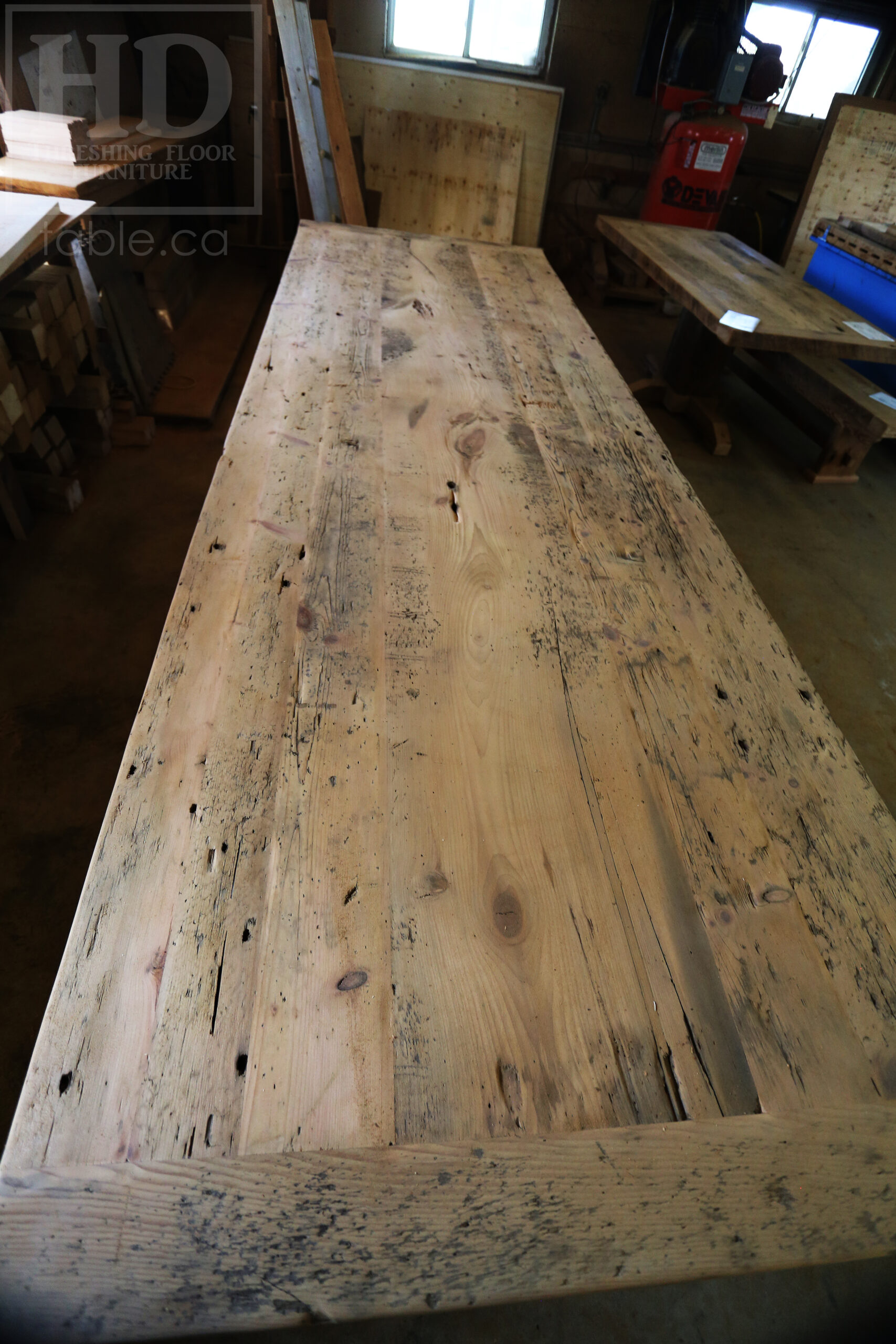 Project Summary: 12â€™ Reclaimed Ontario Barnwood Harvest Table â€“ Tapered with a Notch Windbrace Beam Legs - Old Growth Hemlock Threshing Floor 2â€ Construction - Original edges & distressing maintained â€“ Bread Edge Boards â€“- Premium epoxy + satin polyurethane finish - www.table.ca