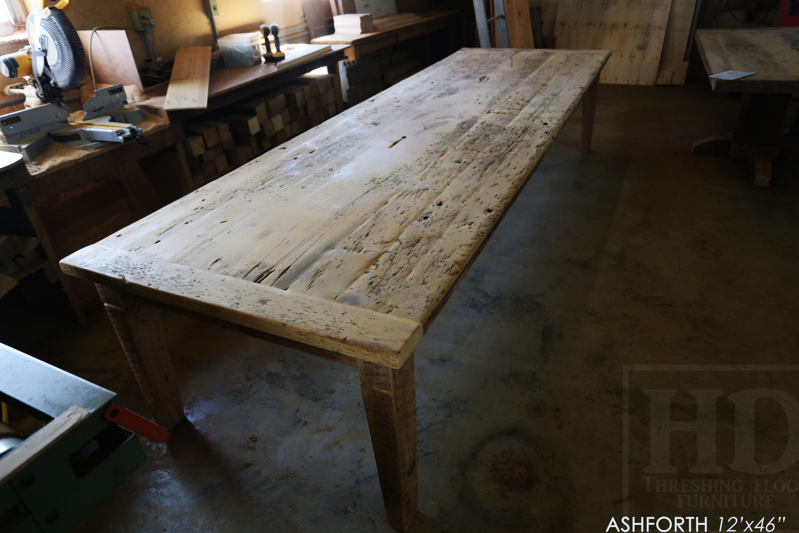 Project Summary: 12â€™ Reclaimed Ontario Barnwood Harvest Table â€“ Tapered with a Notch Windbrace Beam Legs - Old Growth Hemlock Threshing Floor 2â€ Construction - Original edges & distressing maintained â€“ Bread Edge Boards â€“- Premium epoxy + satin polyurethane finish - www.table.ca