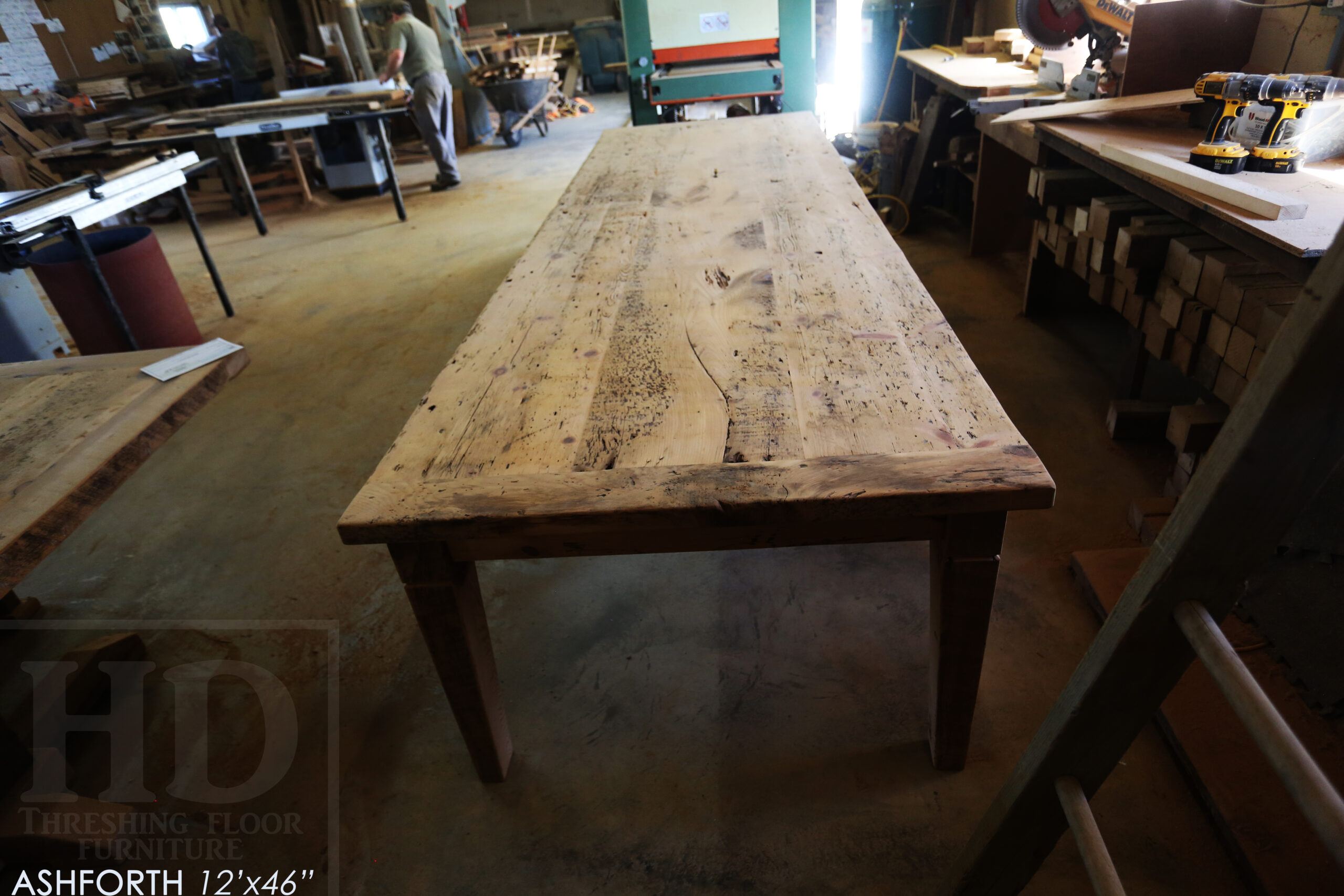 Project Summary: 12â€™ Reclaimed Ontario Barnwood Harvest Table â€“ Tapered with a Notch Windbrace Beam Legs - Old Growth Hemlock Threshing Floor 2â€ Construction - Original edges & distressing maintained â€“ Bread Edge Boards â€“- Premium epoxy + satin polyurethane finish - www.table.ca