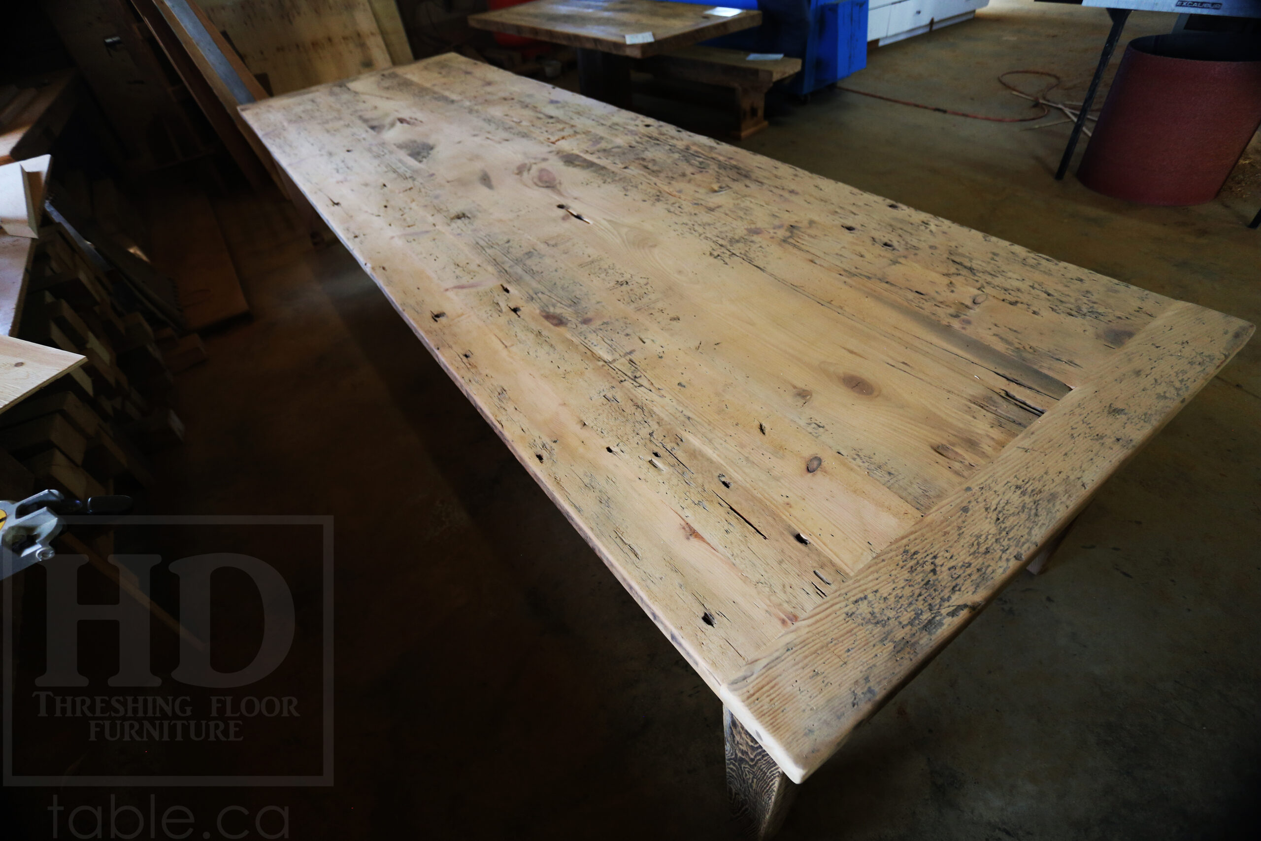 Project Summary: 12â€™ Reclaimed Ontario Barnwood Harvest Table â€“ Tapered with a Notch Windbrace Beam Legs - Old Growth Hemlock Threshing Floor 2â€ Construction - Original edges & distressing maintained â€“ Bread Edge Boards â€“- Premium epoxy + satin polyurethane finish - www.table.ca