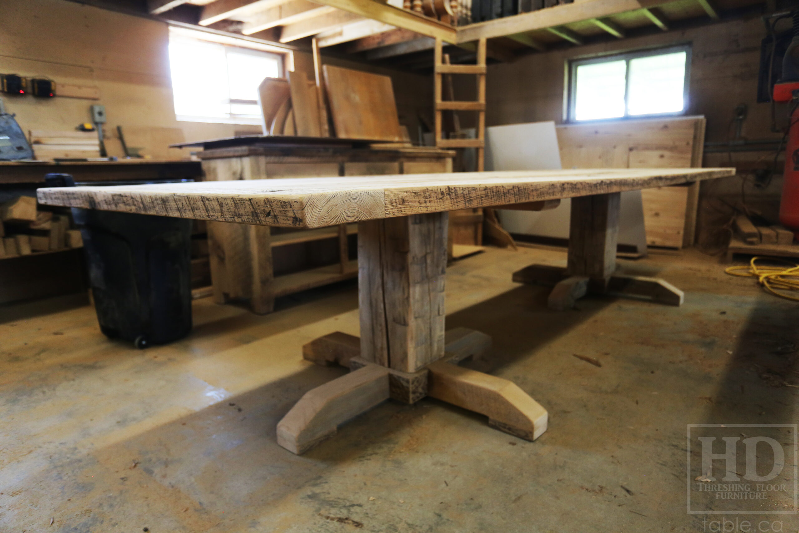 Project Summary: 12’ Reclaimed Ontario Barnwood Table we made for a Fergus, Ontario Company – 48” wide – Metal Logo Embedded - Hand Hewn Beam Pedestals Base - Old Growth Hemlock Threshing Floor Construction - Original edges & distressing maintained – Bread Edge Boards – Greytone Option - Premium epoxy + satin polyurethane finish – www.table.ca