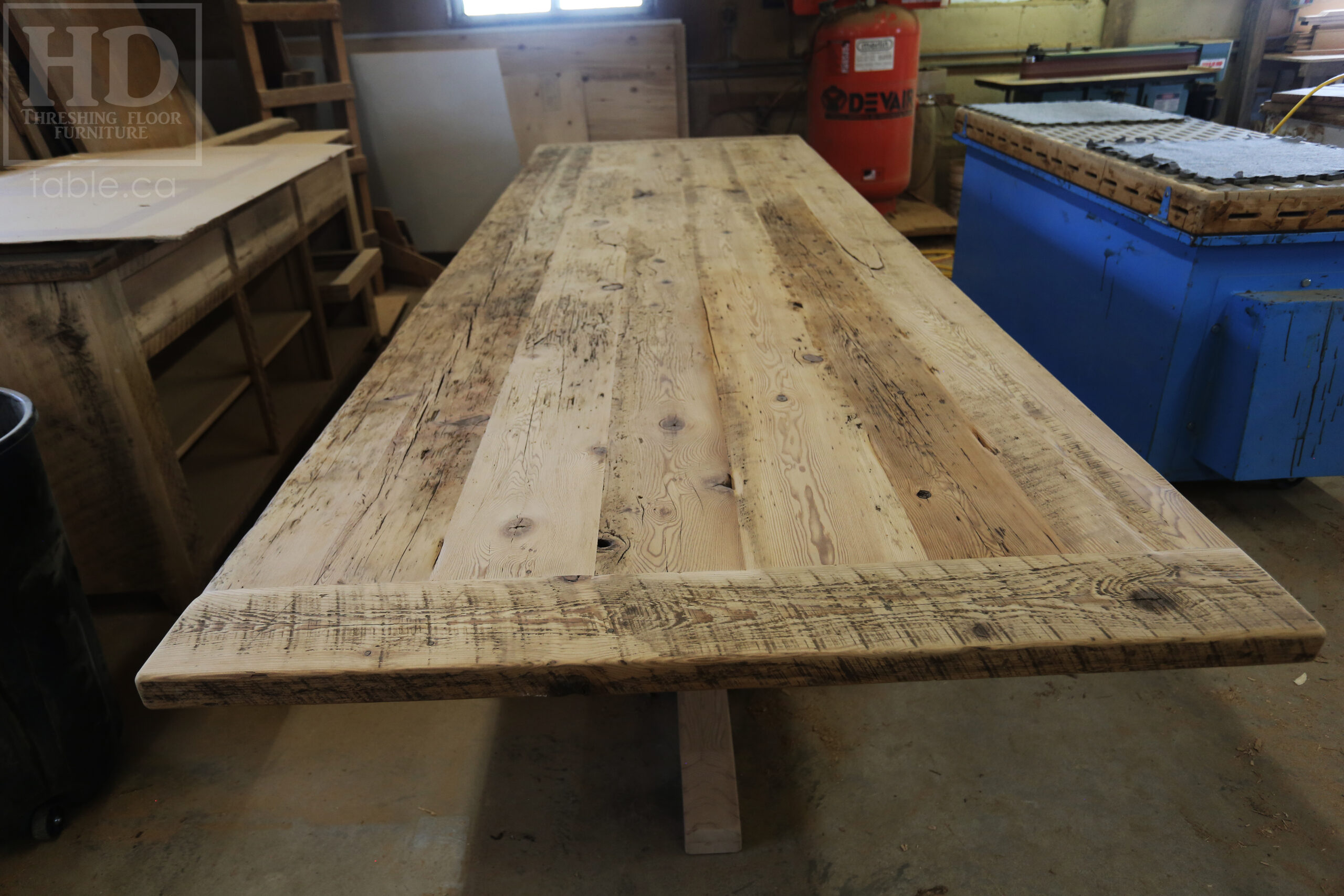 Project Summary: 12’ Reclaimed Ontario Barnwood Table we made for a Fergus, Ontario Company – 48” wide – Metal Logo Embedded - Hand Hewn Beam Pedestals Base - Old Growth Hemlock Threshing Floor Construction - Original edges & distressing maintained – Bread Edge Boards – Greytone Option - Premium epoxy + satin polyurethane finish – www.table.ca