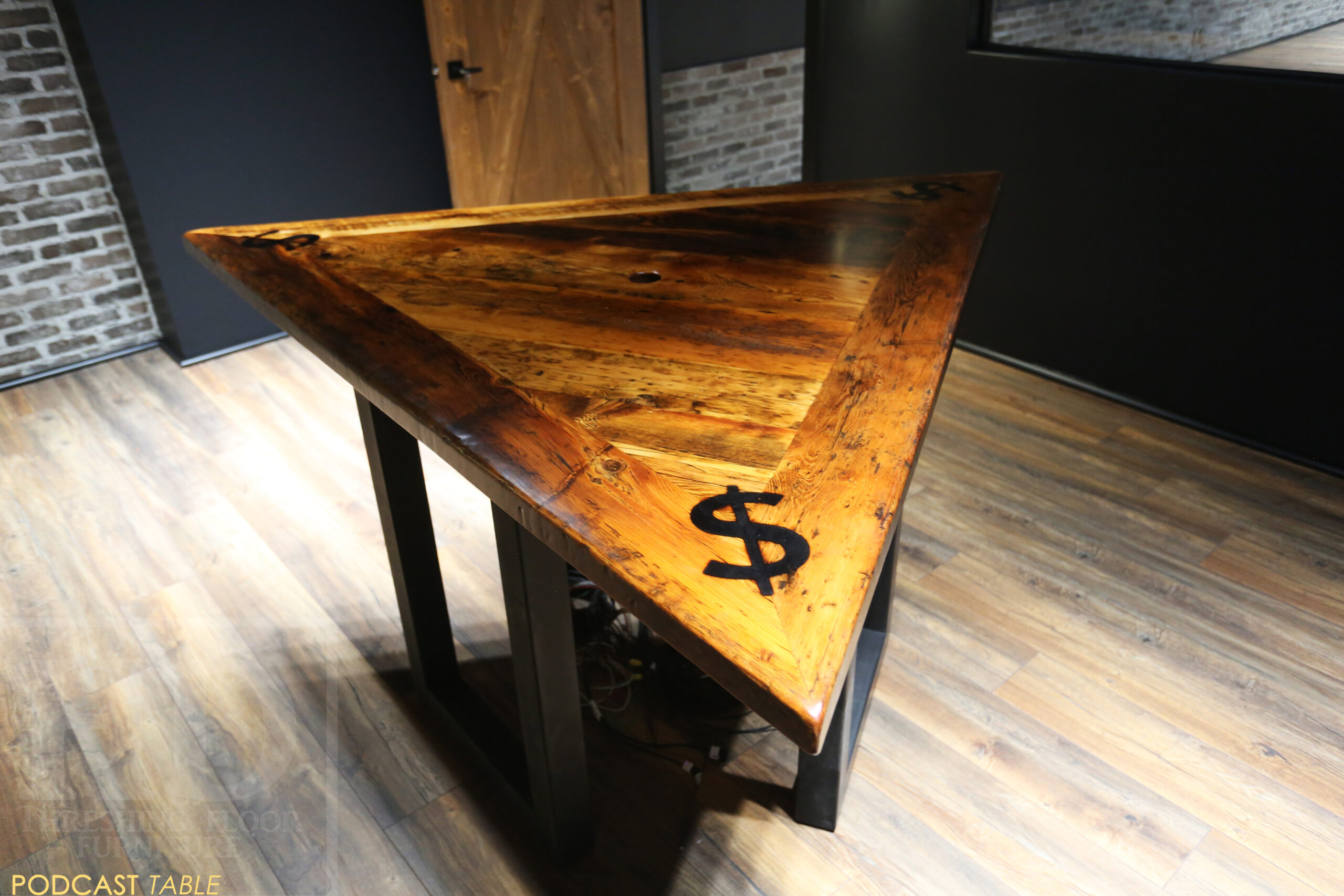 Project Summary: 6’ Per Side Triangle Reclaimed Ontario Barnwood Podcast Table - Made for a Burlington, Ontario home – 36” height – 3 Metal U Shaped Posts - Mitred Corners - Old Growth Hemlock Threshing Floor Construction - Original edges & distressing maintained - Premium epoxy + satin polyurethane finish – Centre Grommet Hole for Electronics - Custom Logo Brand Burn Embedded - www.table.ca