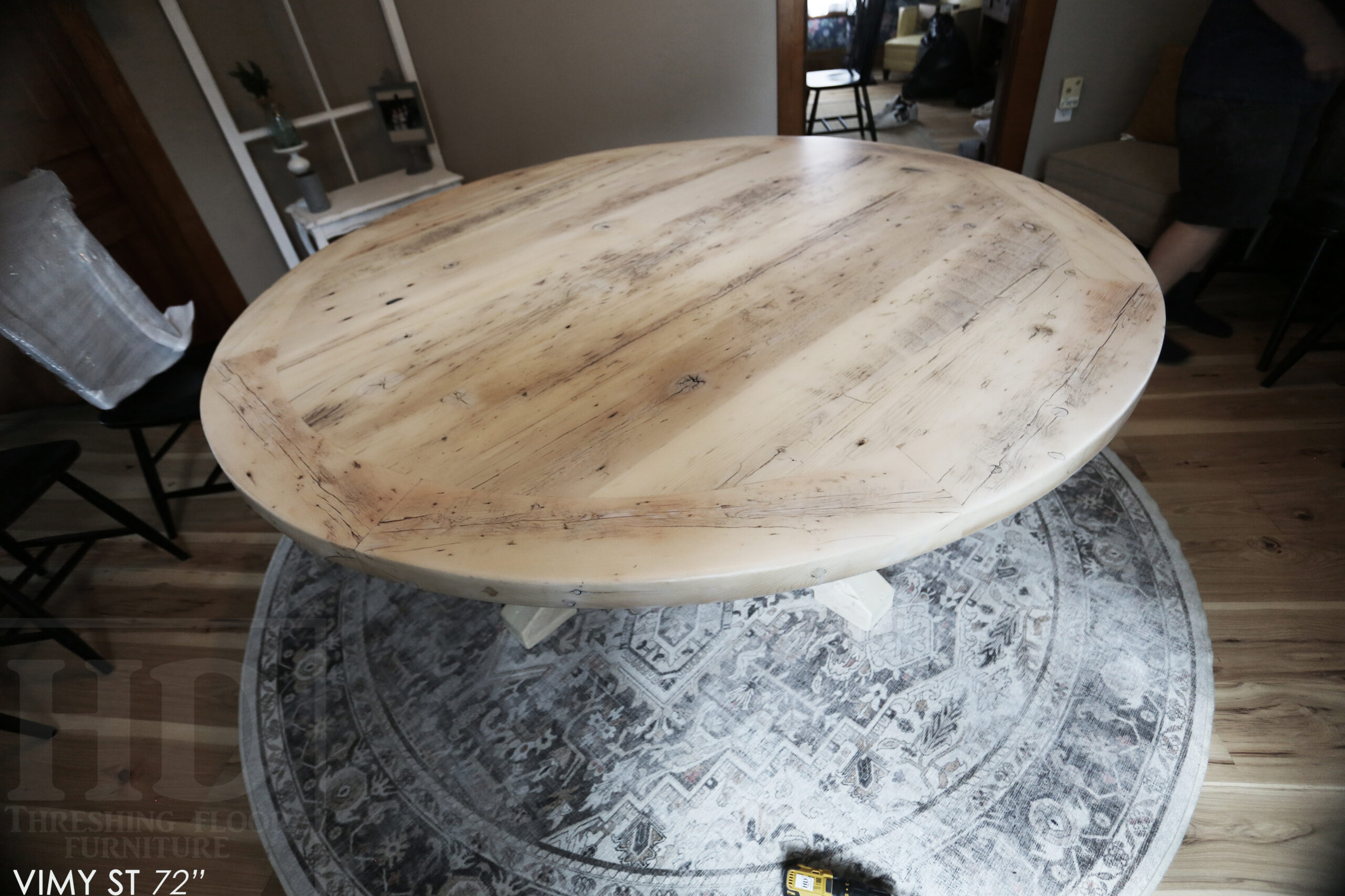 Project Summary: 72â€ Reclaimed Ontario Barnwood Round Table we made for a Cambridge, Ontario home â€“ Hand Hewn Beam Pedestal Base - Old Growth Hemlock Threshing Floor Construction - Original edges & distressing maintained â€“ Bread Edge Boards â€“ Bleached Option - Premium epoxy + matte polyurethane finish - www.table.ca