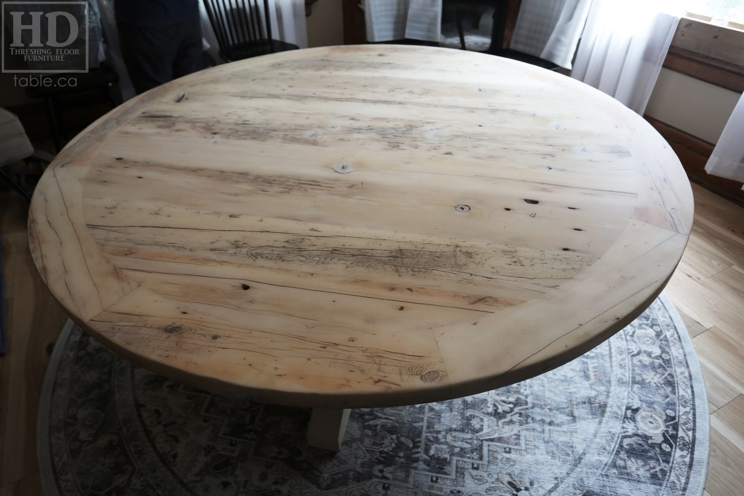 Project Summary: 72â€ Reclaimed Ontario Barnwood Round Table we made for a Cambridge, Ontario home â€“ Hand Hewn Beam Pedestal Base - Old Growth Hemlock Threshing Floor Construction - Original edges & distressing maintained â€“ Bread Edge Boards â€“ Bleached Option - Premium epoxy + matte polyurethane finish - www.table.ca