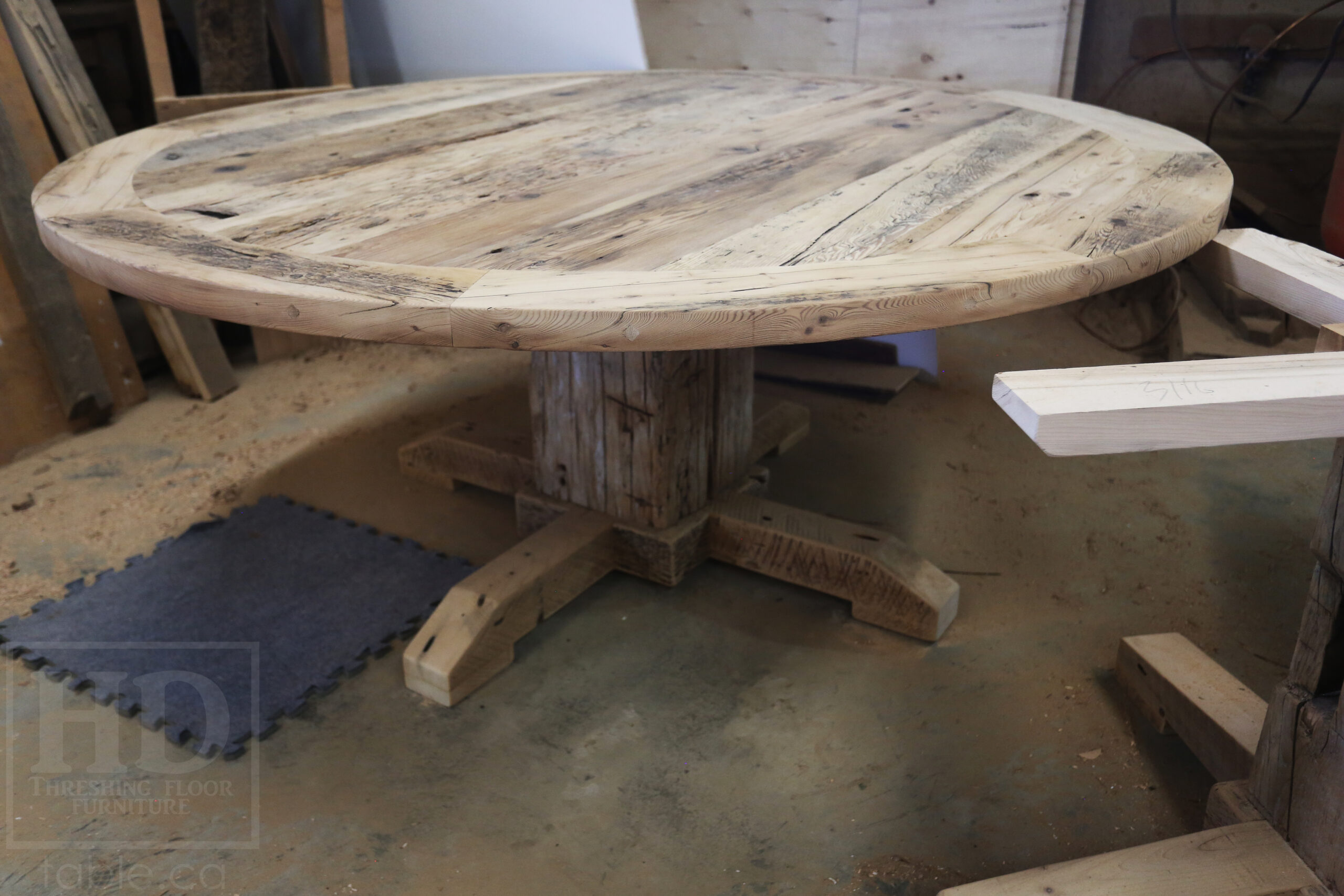 Project Summary: 72â€ Reclaimed Ontario Barnwood Round Table we made for a Cambridge, Ontario home â€“ Hand Hewn Beam Pedestal Base - Old Growth Hemlock Threshing Floor Construction - Original edges & distressing maintained â€“ Bread Edge Boards â€“ Bleached Option - Premium epoxy + matte polyurethane finish - www.table.ca