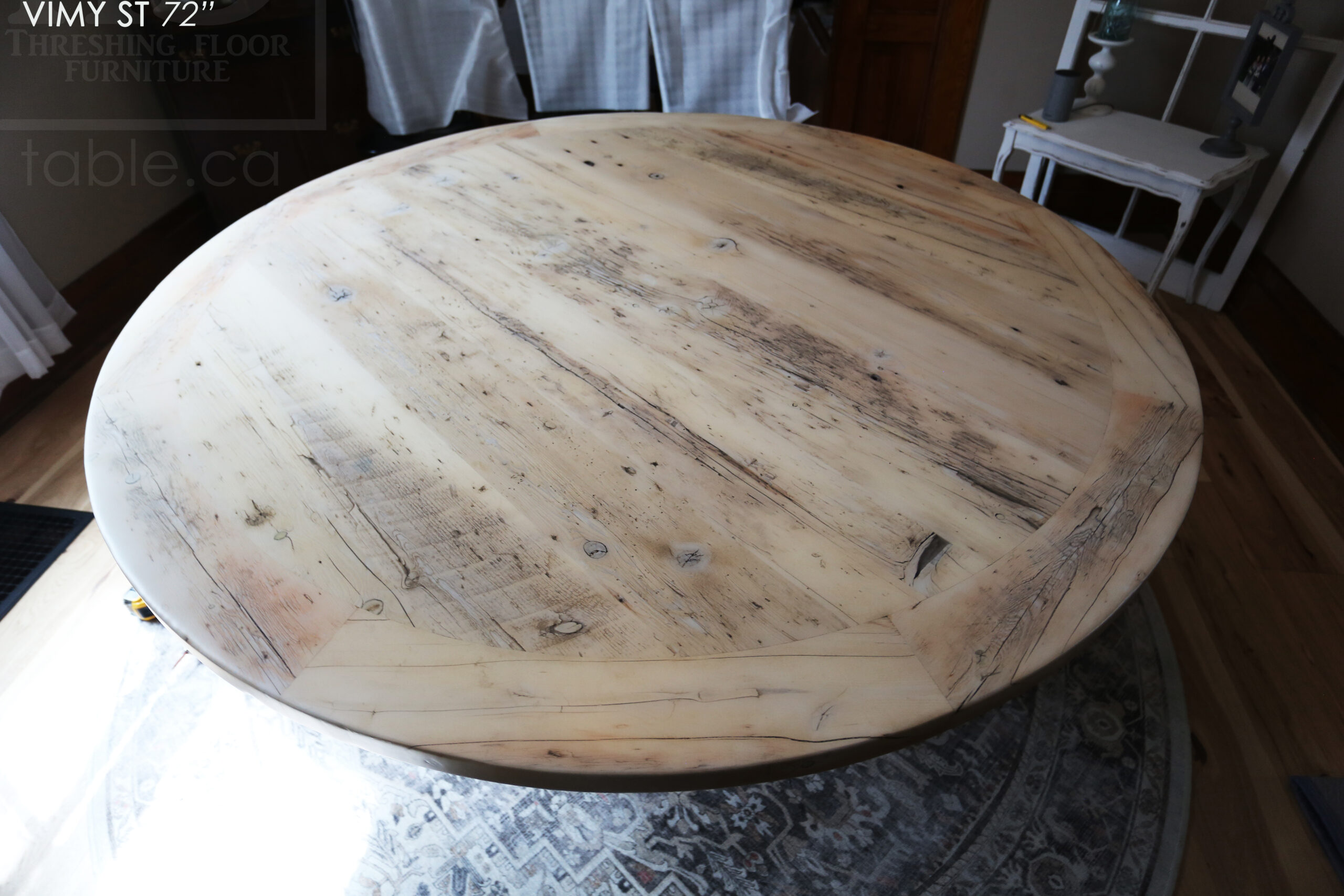 Project Summary: 72â€ Reclaimed Ontario Barnwood Round Table we made for a Cambridge, Ontario home â€“ Hand Hewn Beam Pedestal Base - Old Growth Hemlock Threshing Floor Construction - Original edges & distressing maintained â€“ Bread Edge Boards â€“ Bleached Option - Premium epoxy + matte polyurethane finish - www.table.ca