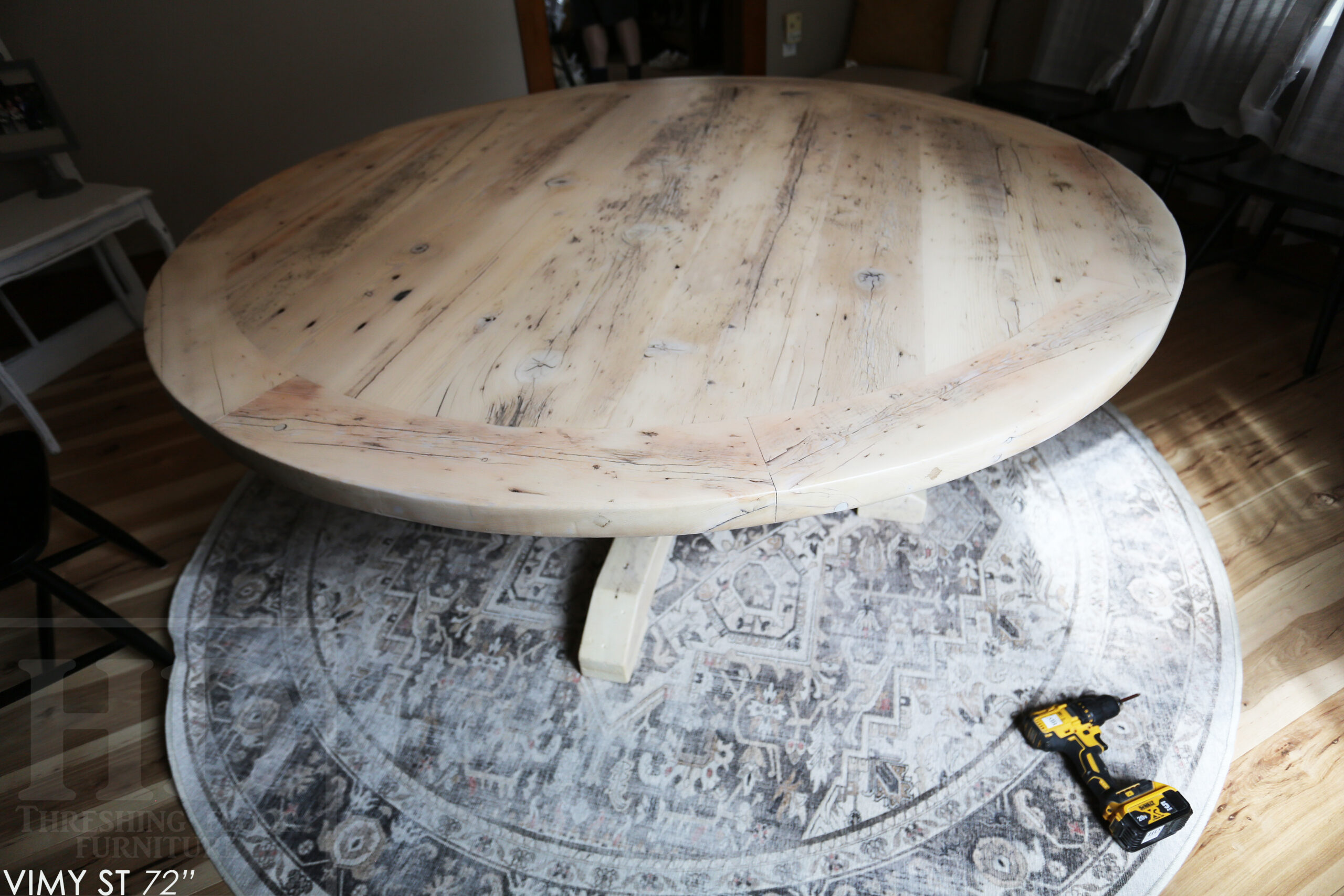 Project Summary: 72” Reclaimed Ontario Barnwood Round Table we made for a Cambridge, Ontario home – Hand Hewn Beam Pedestal Base - Old Growth Hemlock Threshing Floor Construction - Original edges & distressing maintained – Bread Edge Boards – Bleached Option - Premium epoxy + matte polyurethane finish - www.table.ca