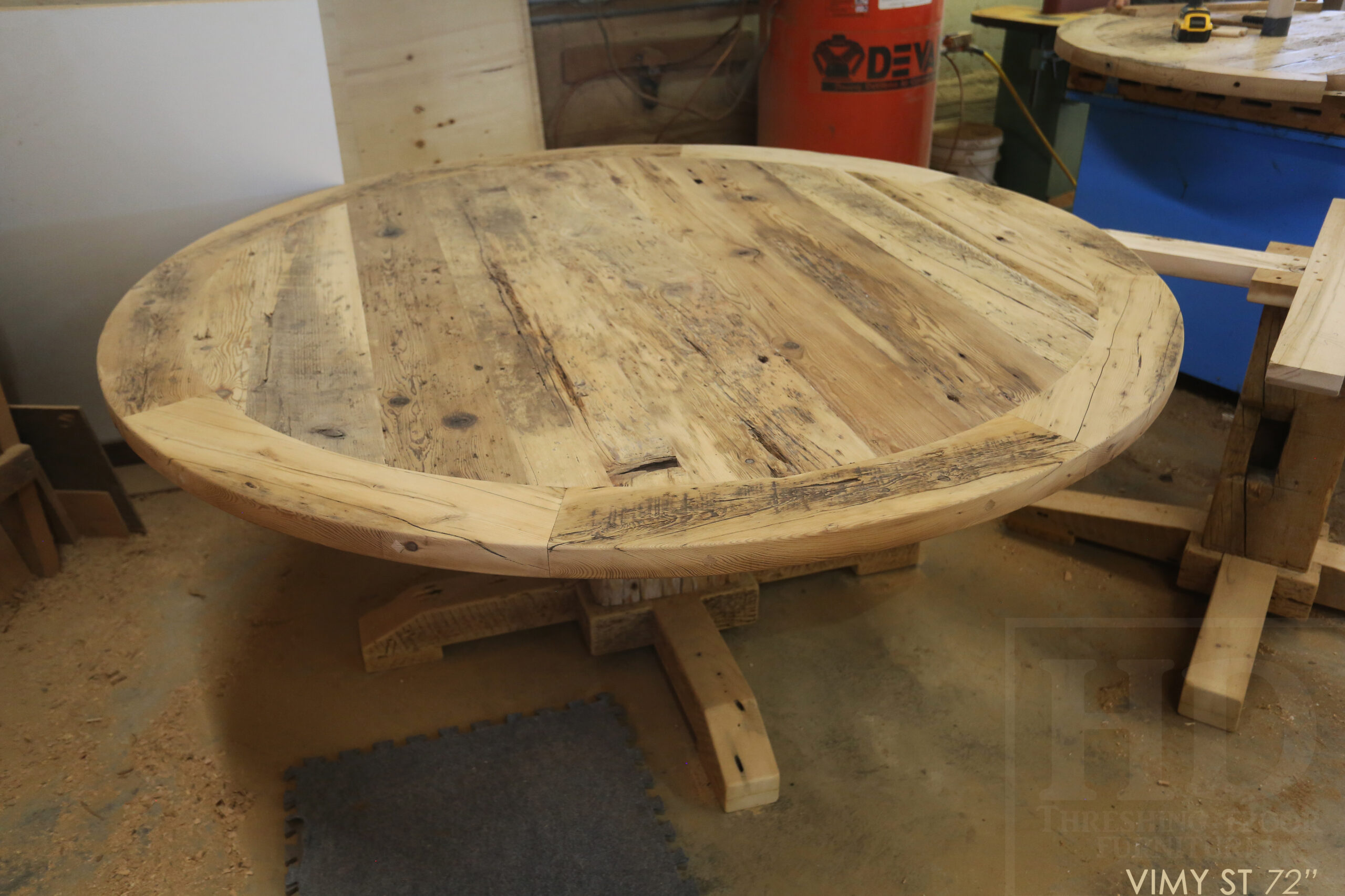 Project Summary: 72â€ Reclaimed Ontario Barnwood Round Table we made for a Cambridge, Ontario home â€“ Hand Hewn Beam Pedestal Base - Old Growth Hemlock Threshing Floor Construction - Original edges & distressing maintained â€“ Bread Edge Boards â€“ Bleached Option - Premium epoxy + matte polyurethane finish - www.table.ca