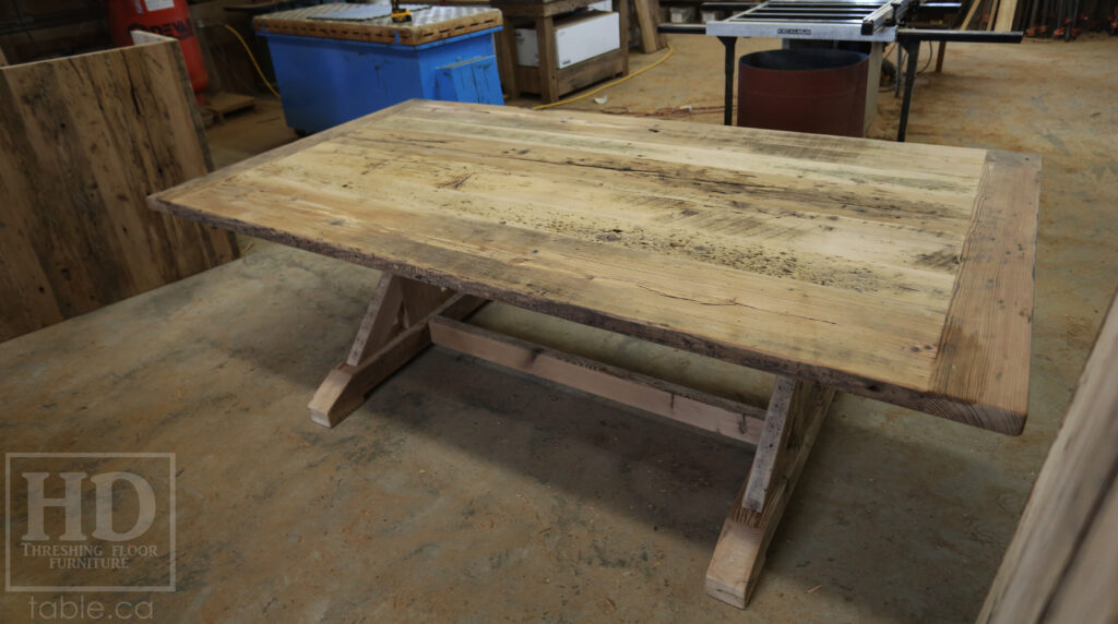 Project Summary: 7’ 6” Reclaimed Ontario Barnwood Table we made for a Fergus, Ontario home – 48” wide – Sawbuck Base - Old Growth Hemlock Threshing Floor Construction - Original edges & distressing maintained – Bread Edge Boards - Premium epoxy + satin polyurethane finish – 7’ 6” [matching] Trestle Bench - www.table.ca