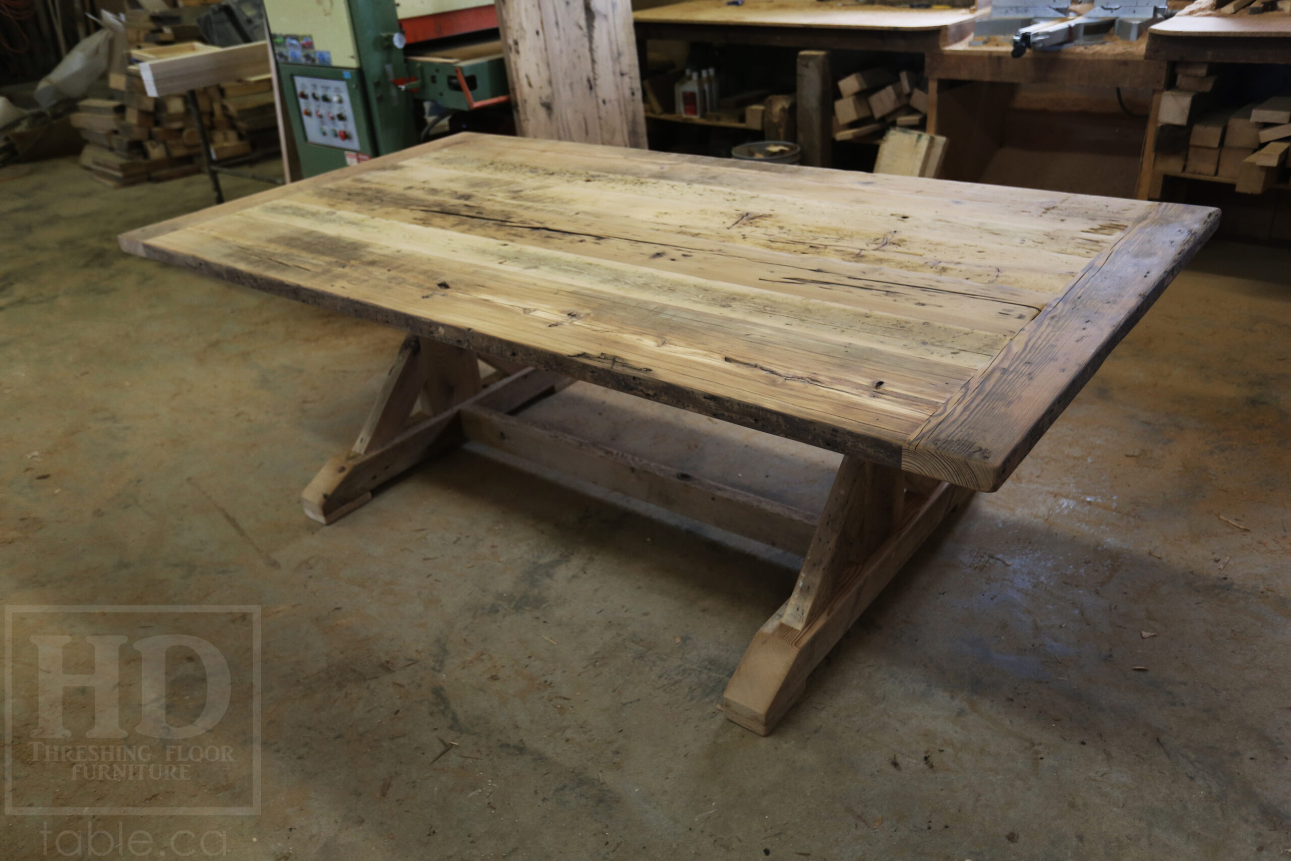 Project Summary: 7’ 6” Reclaimed Ontario Barnwood Table we made for a Fergus, Ontario home – 48” wide – Sawbuck Base - Old Growth Hemlock Threshing Floor Construction - Original edges & distressing maintained – Bread Edge Boards - Premium epoxy + satin polyurethane finish – 7’ 6” [matching] Trestle Bench - www.table.ca