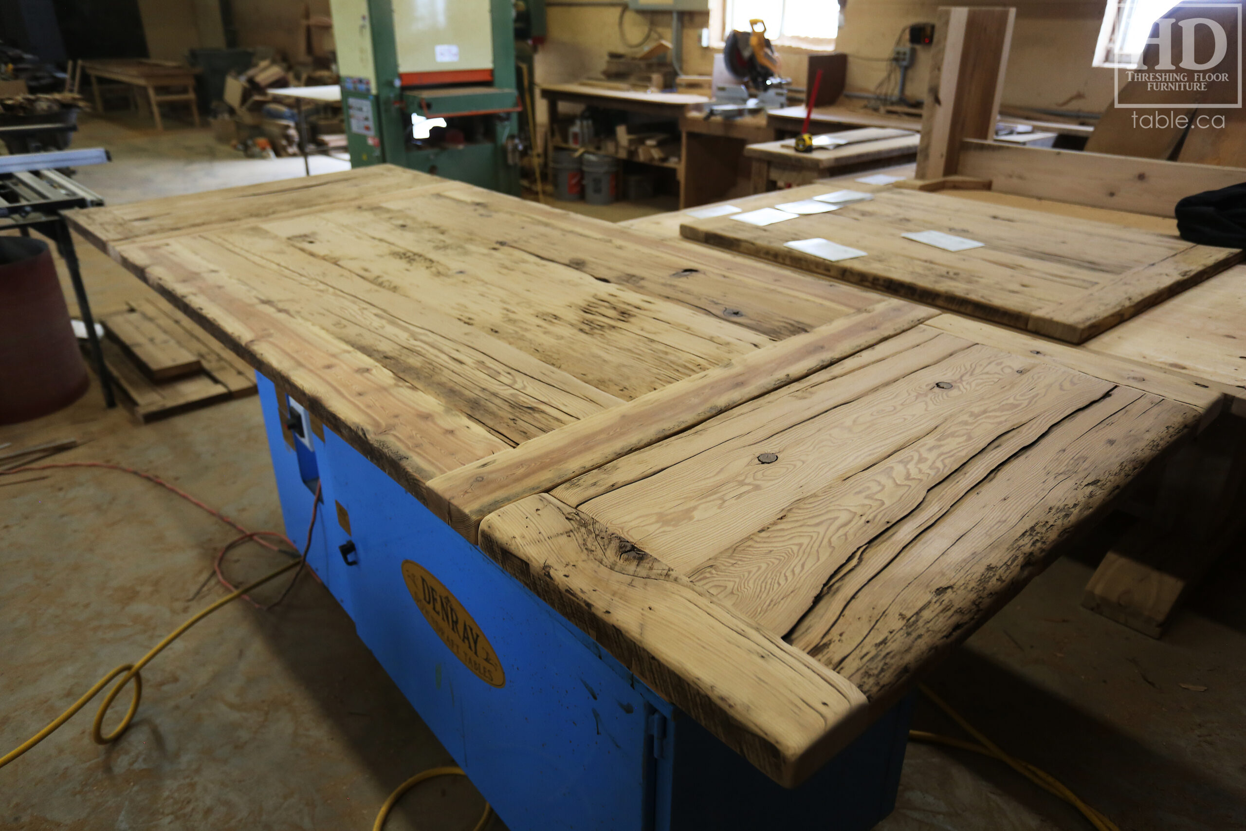 5.5â€™ Ontario Barnwood Table we made for a Dundas, Ontario Home â€“ 40â€ wide â€“ Matte Black X Shaped Base â€“ Skirting + Drawer Option - Old Growth Reclaimed Hemlock Threshing Floor Construction â€“ Original edges & distressing maintained - Premium epoxy + satin polyurethane finish â€“ Two 18â€ leaves - www.table.ca