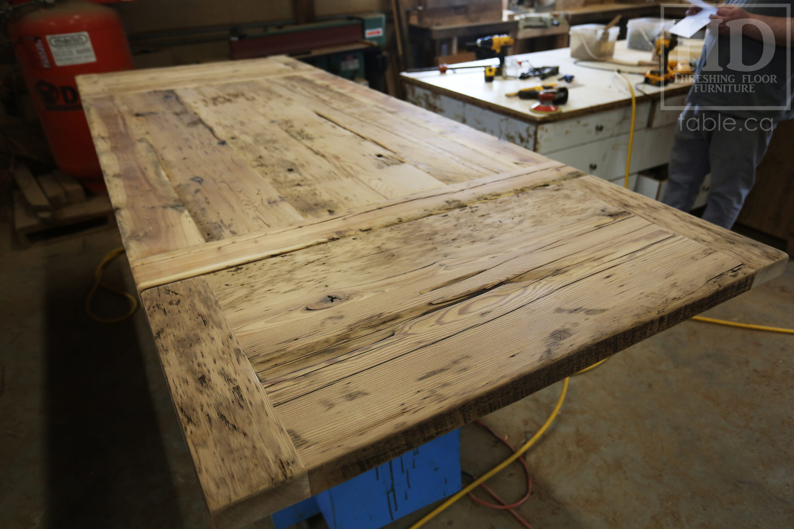 5.5â€™ Ontario Barnwood Table we made for a Dundas, Ontario Home â€“ 40â€ wide â€“ Matte Black X Shaped Base â€“ Skirting + Drawer Option - Old Growth Reclaimed Hemlock Threshing Floor Construction â€“ Original edges & distressing maintained - Premium epoxy + satin polyurethane finish â€“ Two 18â€ leaves - www.table.ca